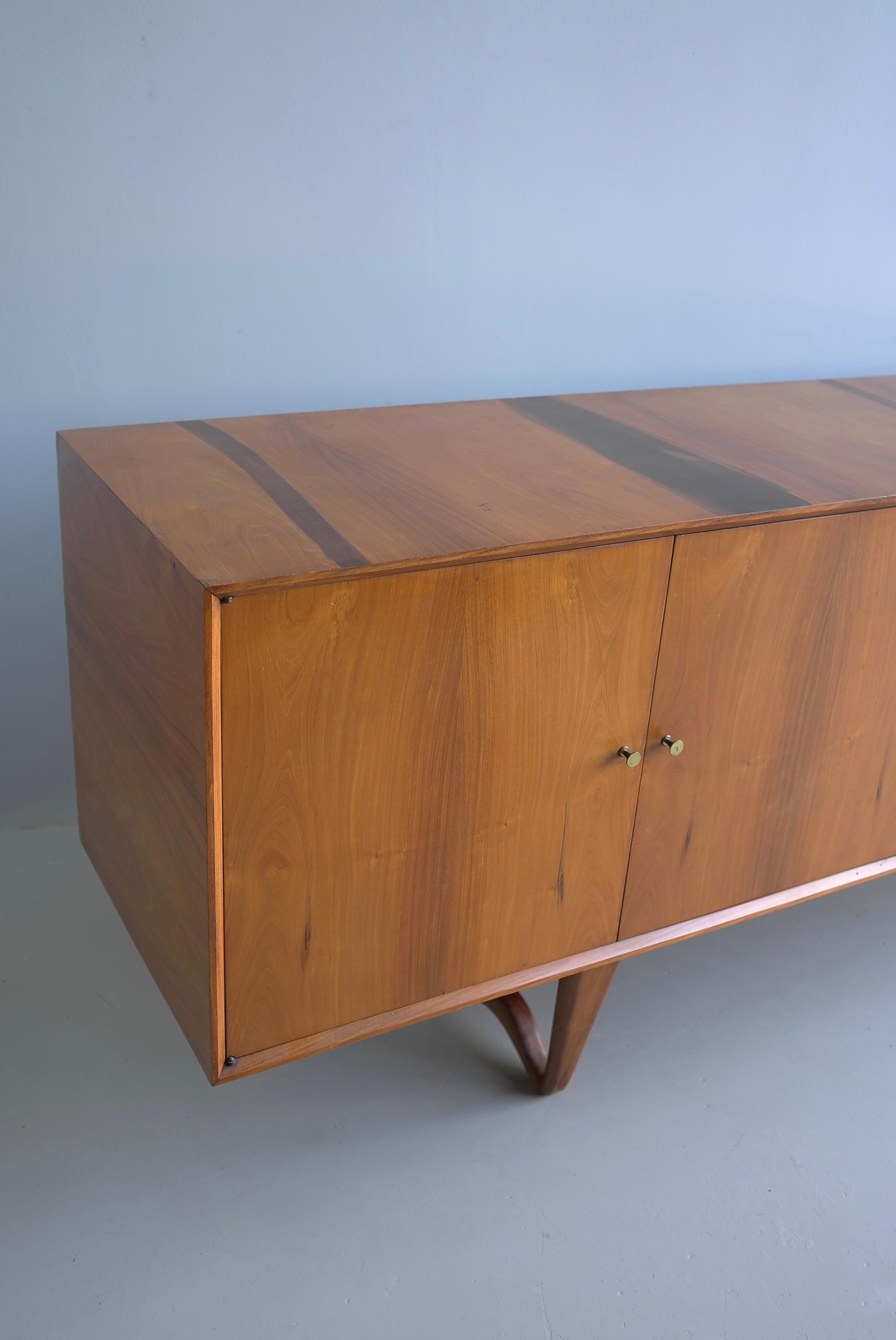 Sculptural Credenza-Sideboard by Giuseppe Scapinelli in Walnut, Brazil, 1950s

The elegant base and finish of detail are quality. The sideboard still has some original 1950's brazilian stamps and moving notes on the back.

Please notice!! we only