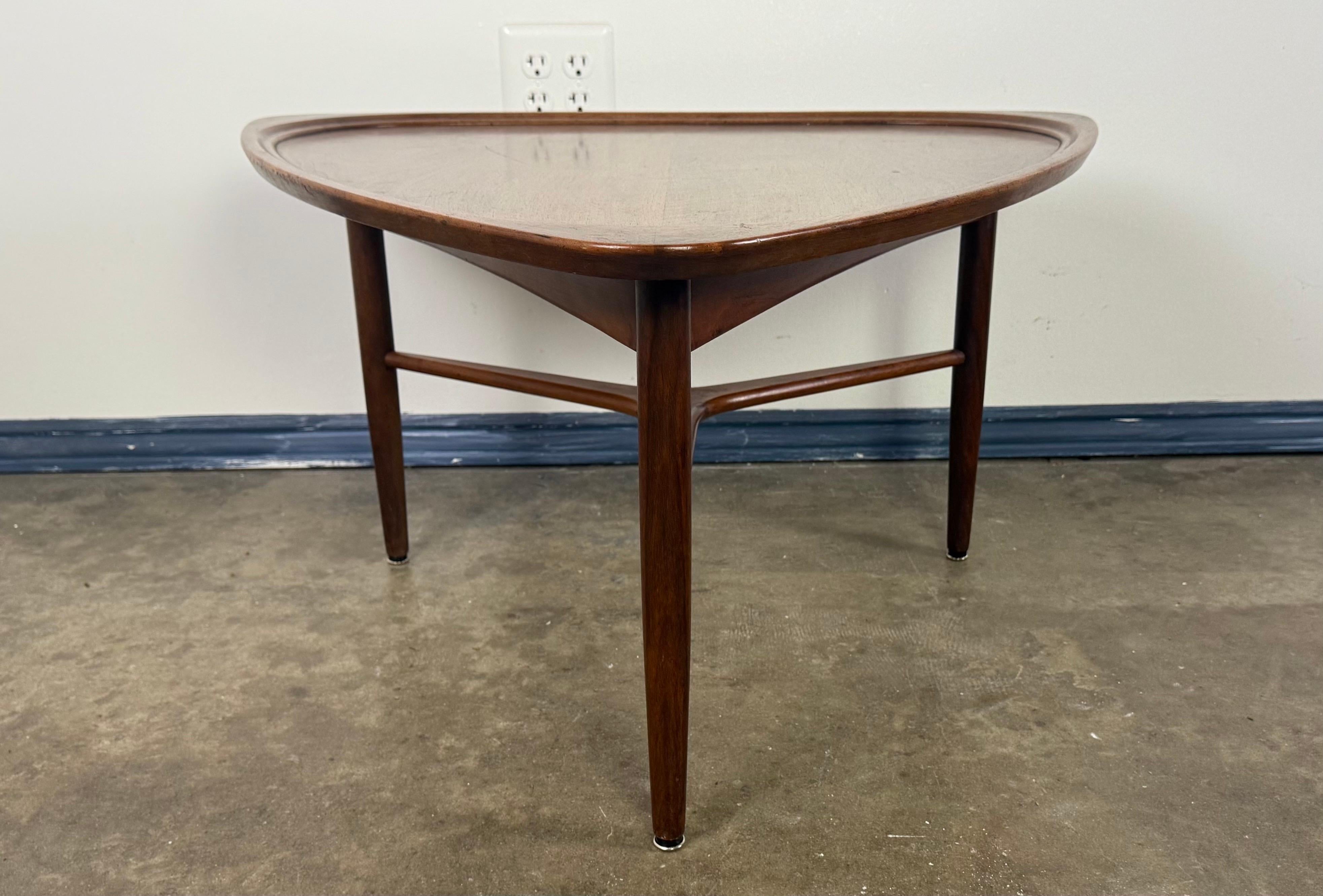 A striking example of Danish Modern design, this sculptural walnut coffee table dates to the late 1950s or early 1960s and was imported to California by the esteemed Schwartz Company of Los Angeles. Crafted in Denmark, the table features an elegant