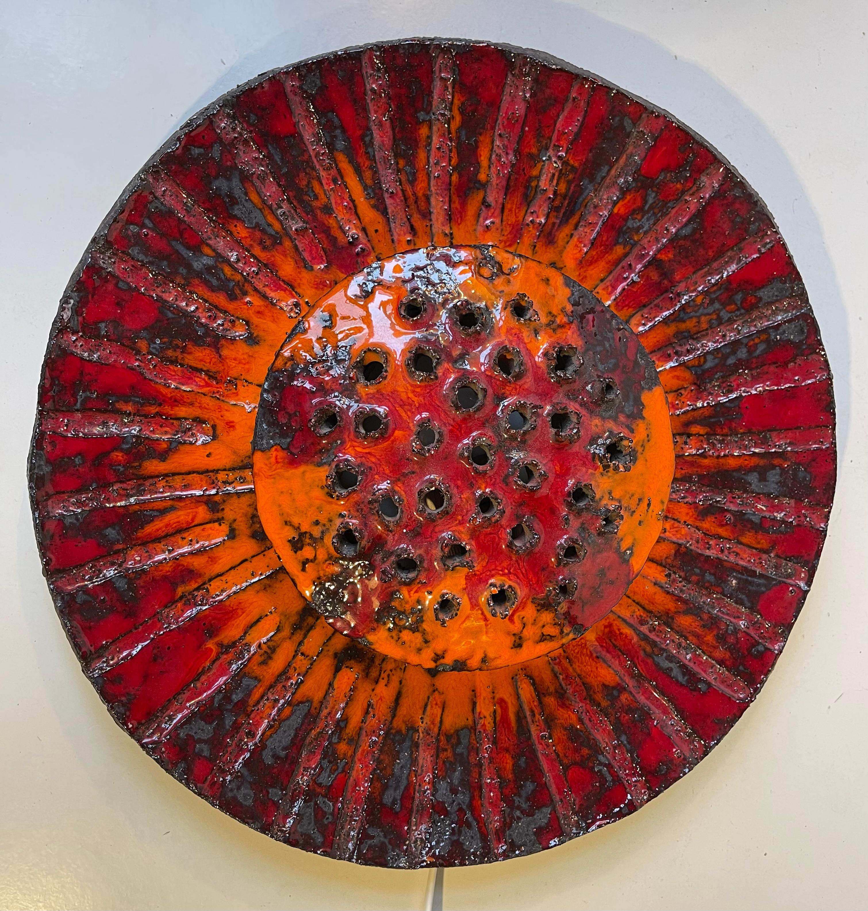 Piece unique - one of a kind sculptural wall light executed in glazes ceramic/stoneware.. Vibrant high-gloss orange and red acid and fat lava glazes sets the flower-power 1970s vibe for this exceptional attention piece. Unknow Danish maker/designer