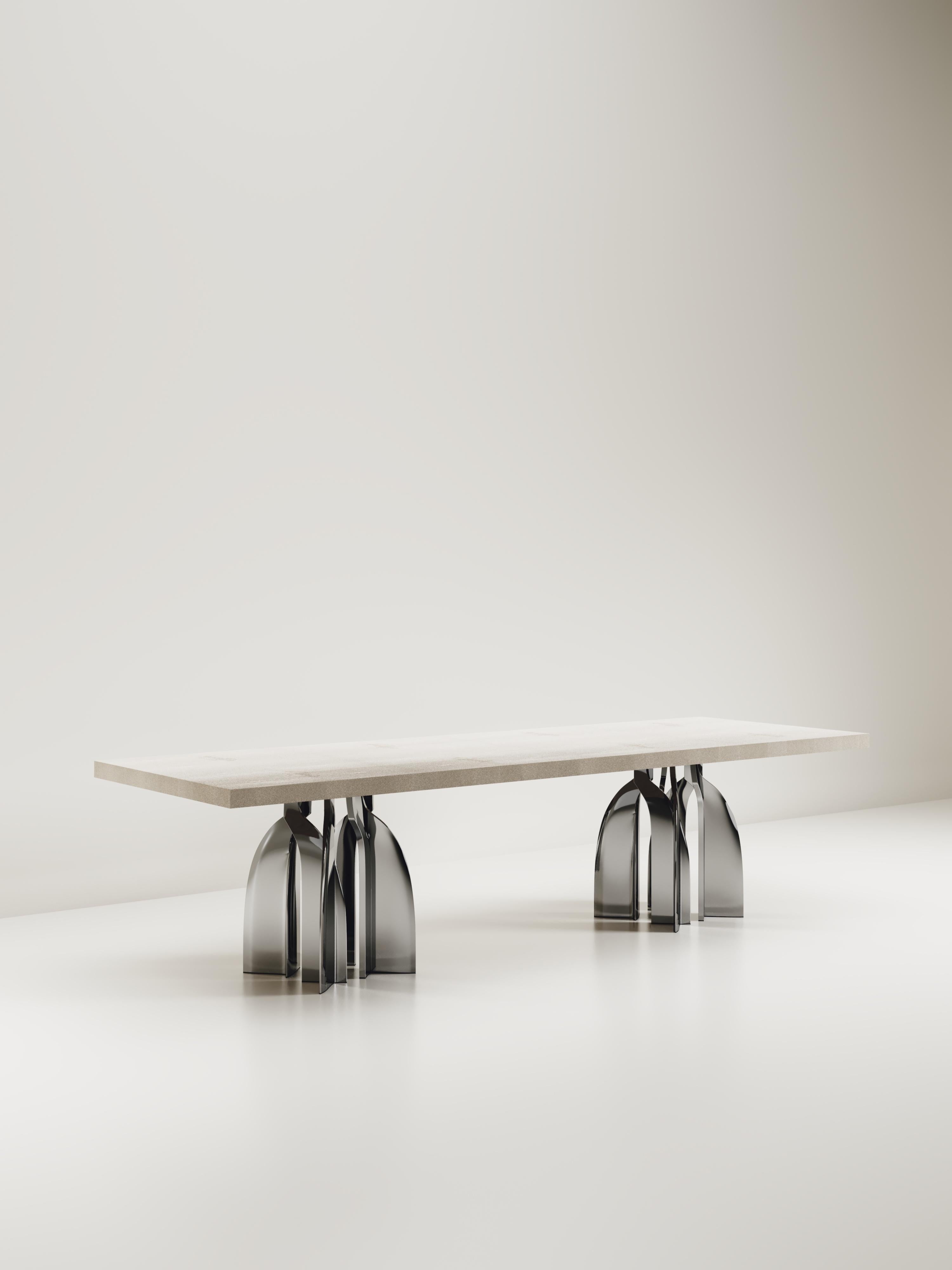 The Chital Dining table is a stunning piece, a statement in any space. The cream shagreen inlaid top is sleek and dramatic, and followed by brushed stainless steel sculptural legs clustered together as the base. This piece is designed by Kifu