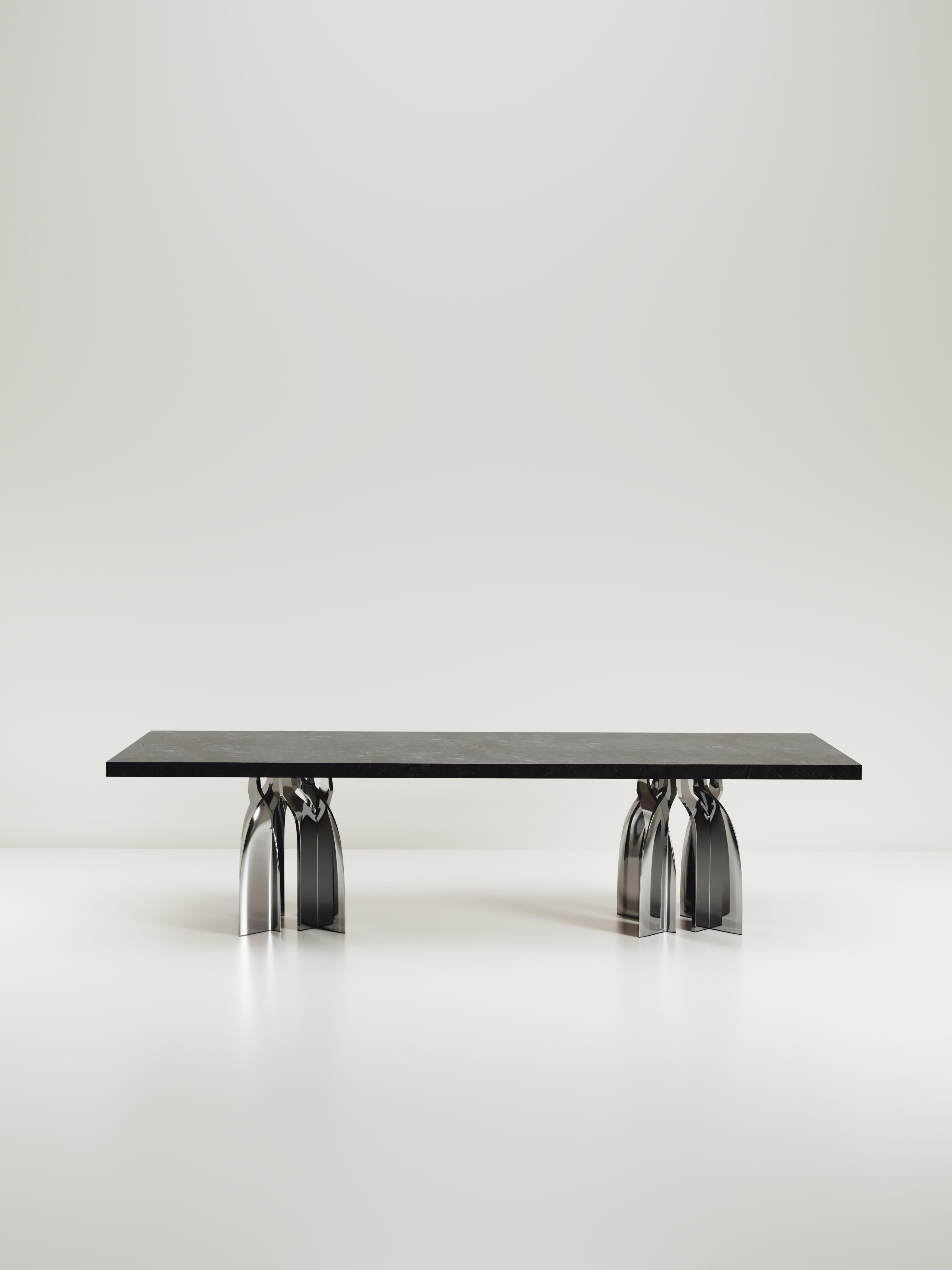 The Chital Dining table is a stunning piece, a statement in any space. The black pen shell inlaid top is sleek and dramatic, and followed by brushed stainless steel sculptural legs clustered together as the base. This piece is designed by Kifu