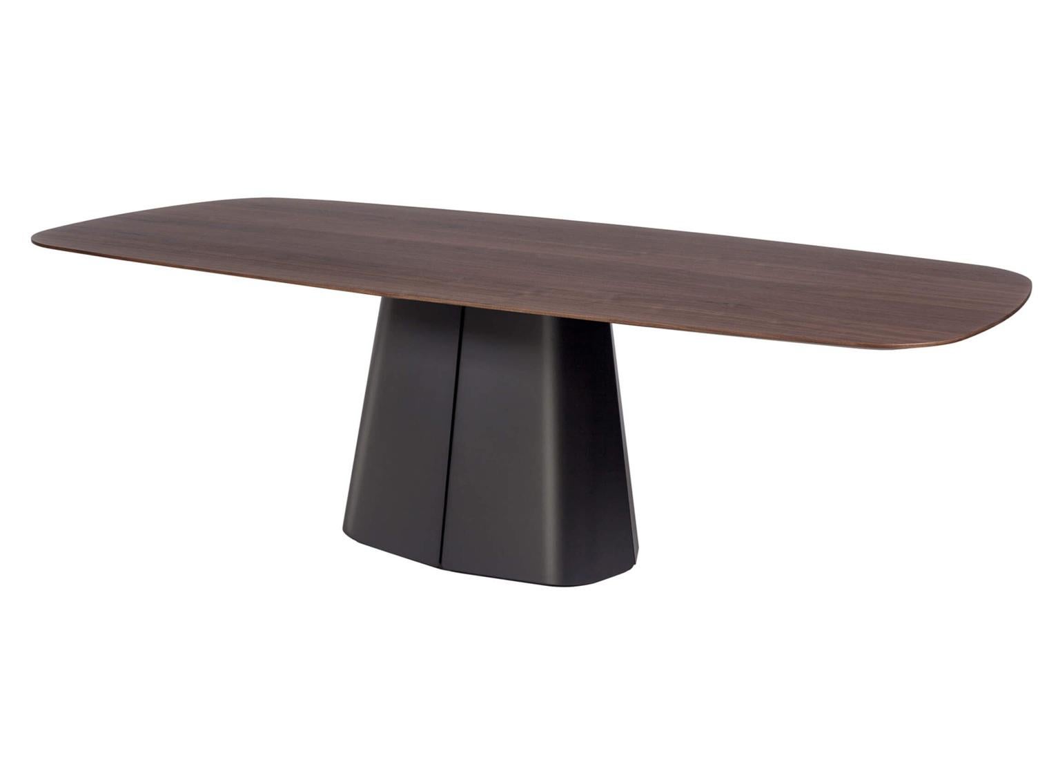 A refined statement piece, this sculptural dining table features a softly contoured rectangular top resting on a bold, tapered plinth base. Crafted in rich walnut, the table showcases a continuous grain flow and seamless transitions between