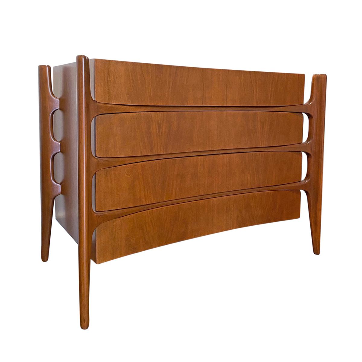 Sculptural Swedish walnut four-drawer dresser by William Hinn. Amazing design with curved concave case, extending into pegged legs which protrude like organic struts. Beautifully matched wood grain on drawer fronts. Marked Stiehl Furniture on side