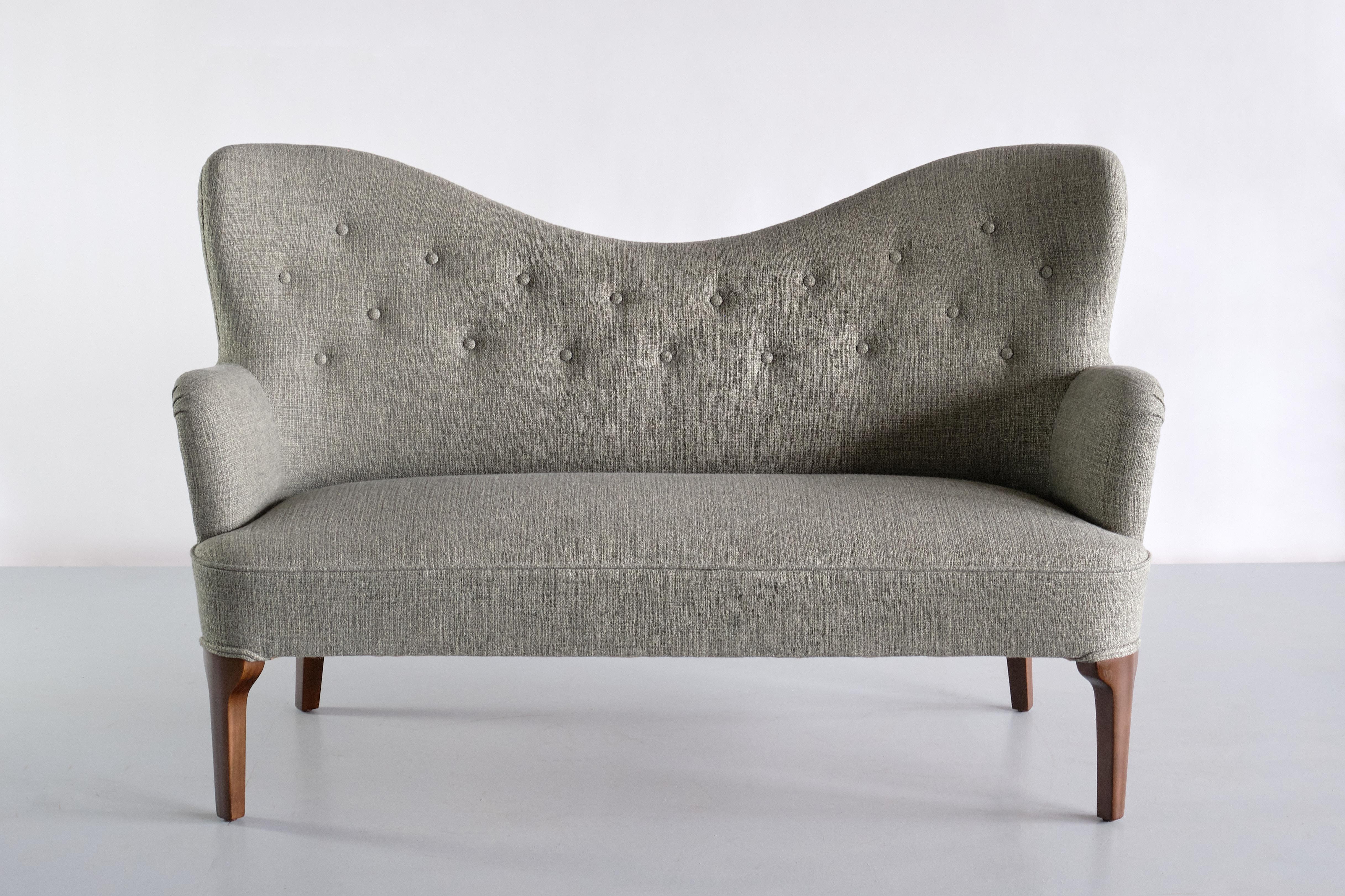 This exceptionally rare two seat sofa was designed by Ernst Kühn for the Wivex restaurant in Copenhagen in the early 1930s. The custom design was most likely produced by the Danish company Normina A/S, the manufacturer Kühn chose to execute most of