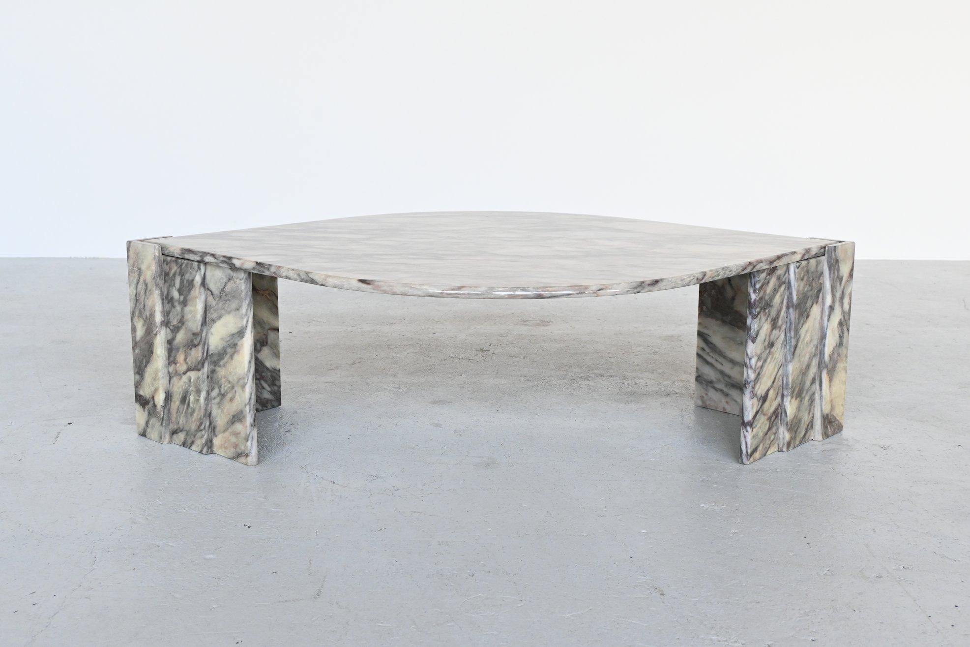 Beautiful sculptural marble coffee table, Italy 1970. The heavy eye-shaped marble top rests on two triangular marble bases. These triangular legs have three built-in layers. The ends of the top lie on the open triangles. The solid marble top is