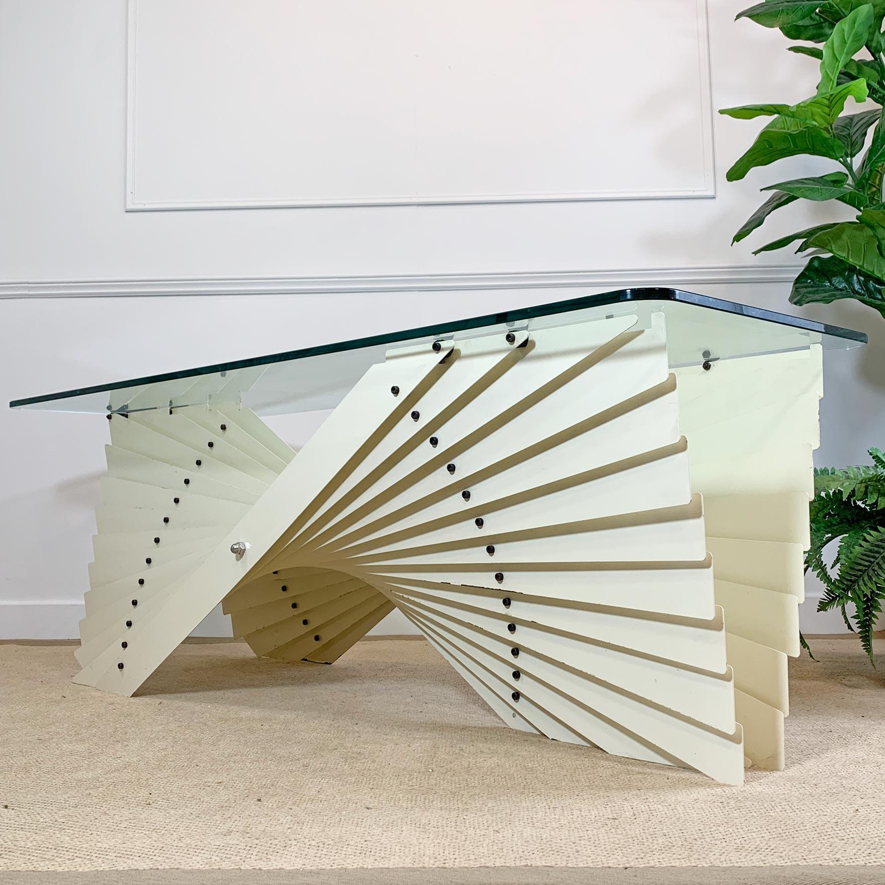 An exceptional Italian designer coffee table from the late 1970’s. This extremely rare table is made from individual steel slats, each painted in an off white palette, and arranged to form the stunning free flowing sculptural fan form which changes