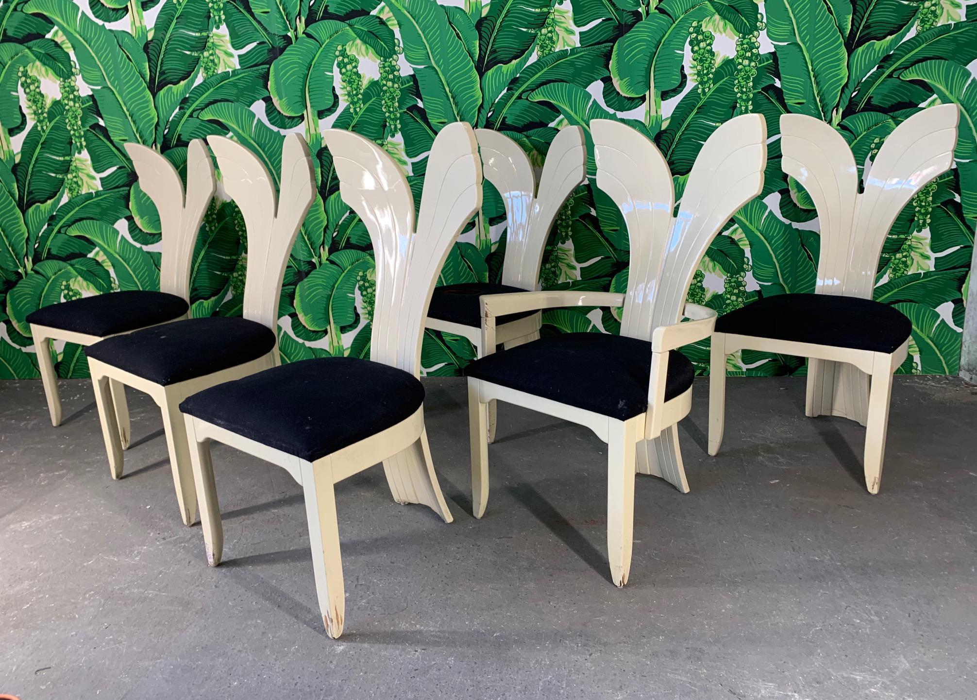 Set of six sculptural dining chairs in a unique fish tail form. Circa 1980s. Hollywood Regency glam at it's finest. Structurally sound. Cushions need replacement/reupholstering. Frames show chips and abrasions. 
 