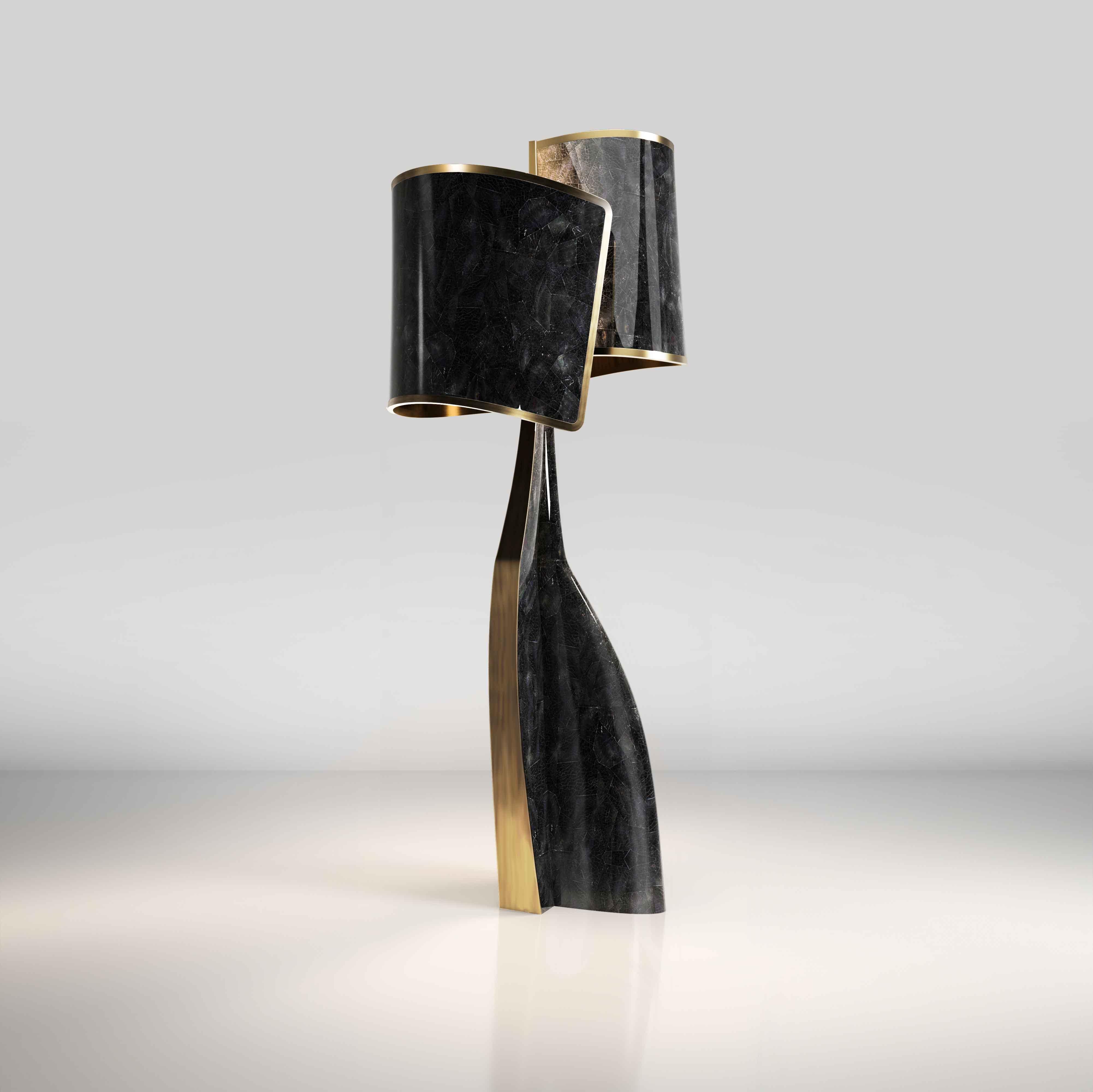 The Chital III Floor Lamp by Kifu Paris is a sleek and sculptural piece, inlaid in a mixture of bronze-patina brass and black pen shell. The chiseled legs, which are an iconic shape within the KIFU PARIS universe, morph into the solid shades that