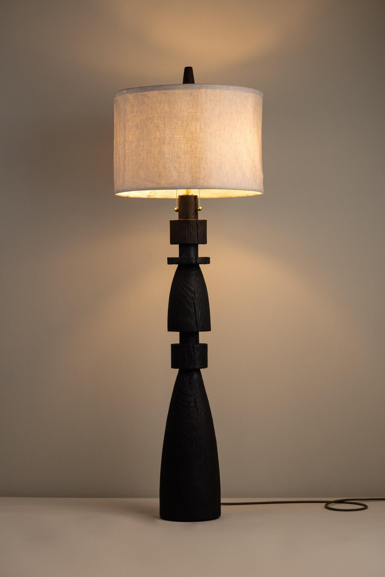 MEZQUITE (LARGE) floor lamp was designed for the De Palo collection by Mexican artist Isabel Moncada.

Like a chess bishop, Mezquite makes its presence felt in a resounding manner. It has a sturdy wood base, its dark finish gives great character and