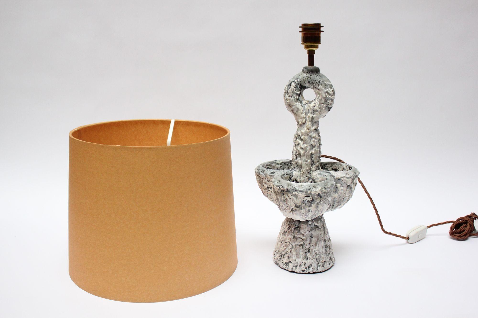 Ceramic table lamp produced by Louis Giraud for his eponymous studio, 'Poterie d'Art Giraud' (Vallauris, France, ca. early 1950s). Giraud's sculptural works were often seen in thick lava glazes. 
This piece is a fine example showcasing Giraud's