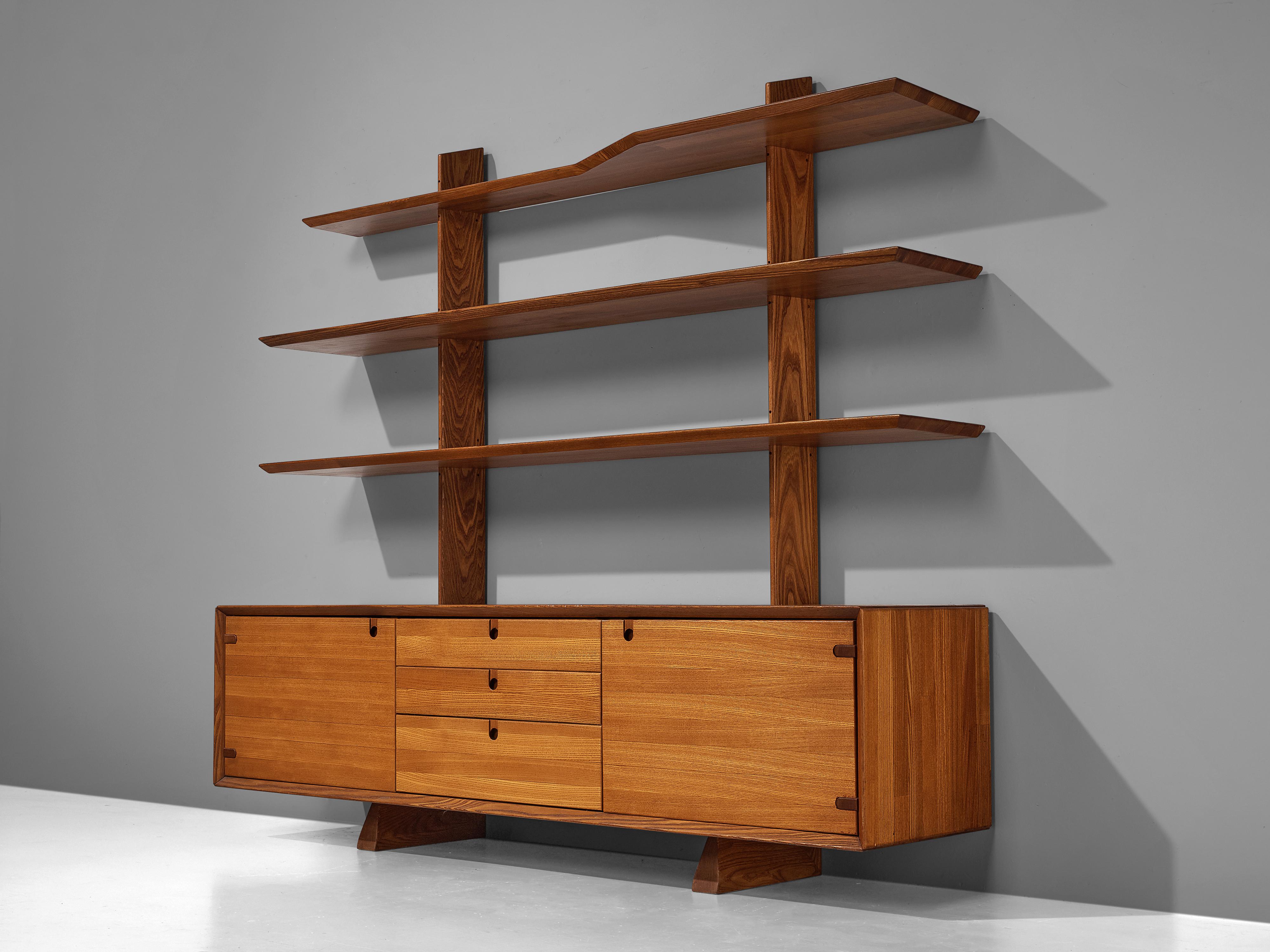 Highboard, elm, France, 1960s

This robust and solid highboard consists of three elm shelves that rest on top of a cabinet. The base of the piece has two doors and three drawers. Therefore, it is a vividly designed piece that is both functional and