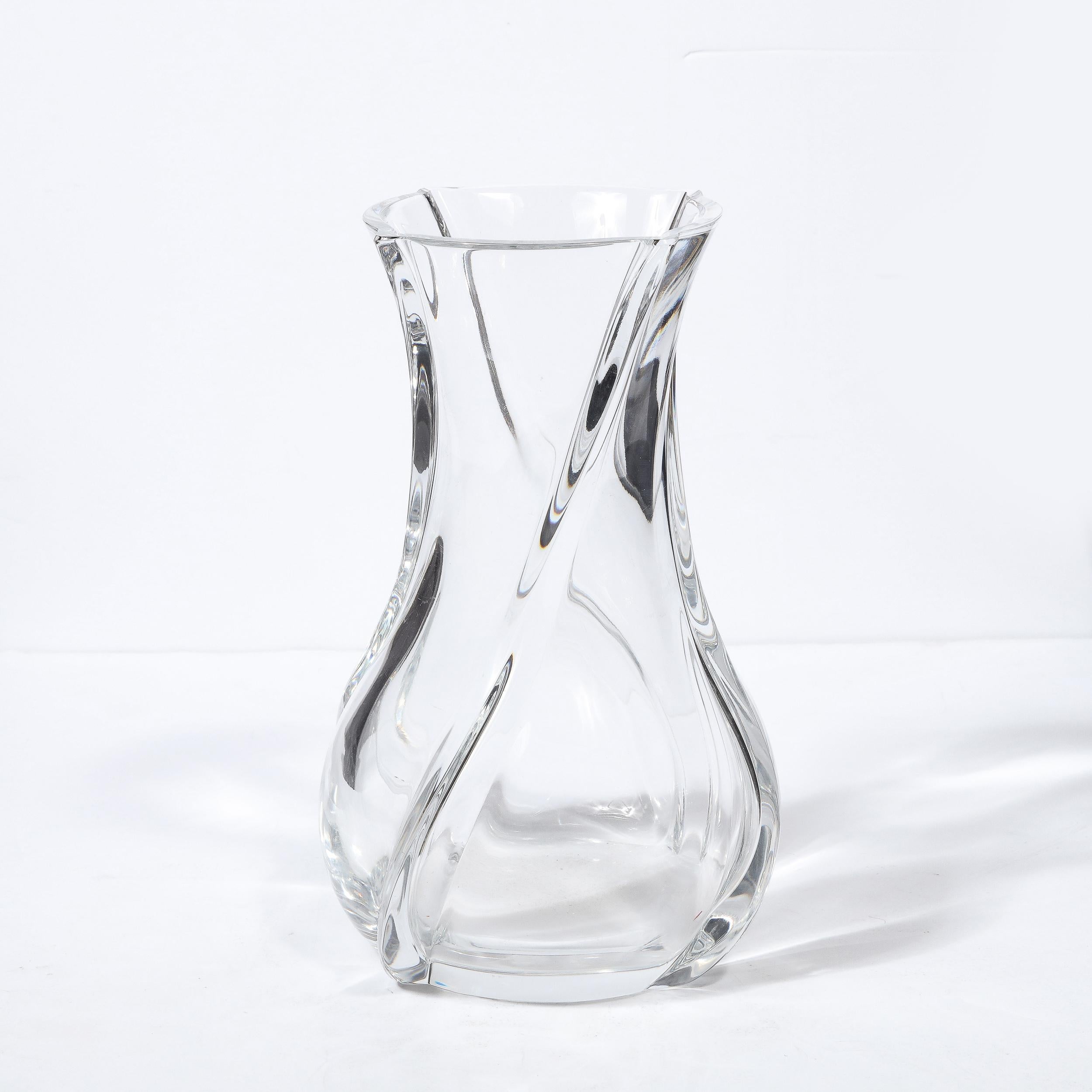 This refined and sculptural translucent crystal vase was realized in France by Baccarat- one of the premiere makers of crystals objects since 1764- during the latter half of the 20th century. A striking example of Baccarat's twist pattern, this