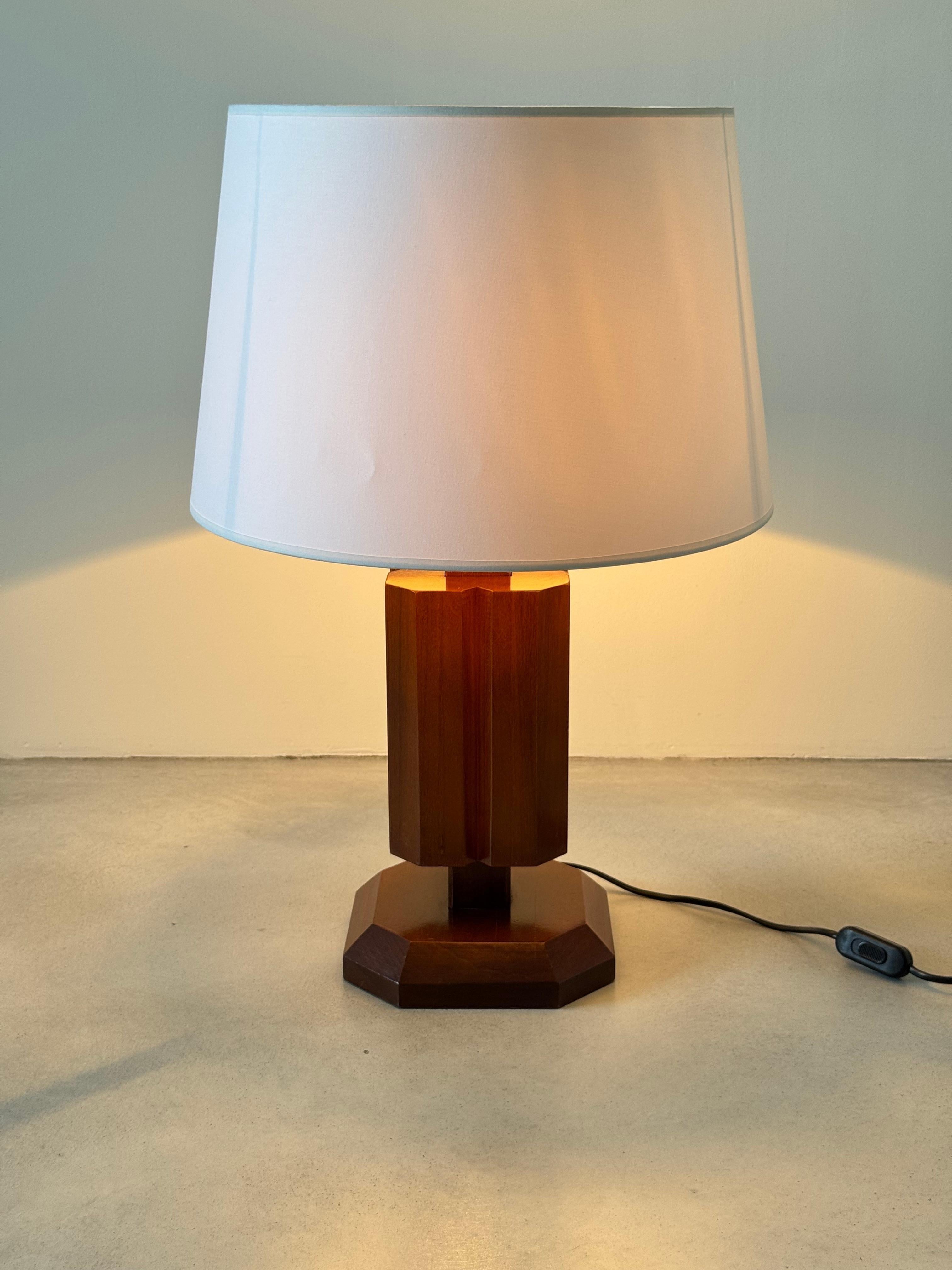 Elevate your interior design with this magnificent and rare French table lamp, a true testament to the Art Deco Revival style of the 1980s. Designed with an architectural and geometric base made of solid hardwood (likely fruitwood or mahogany, given