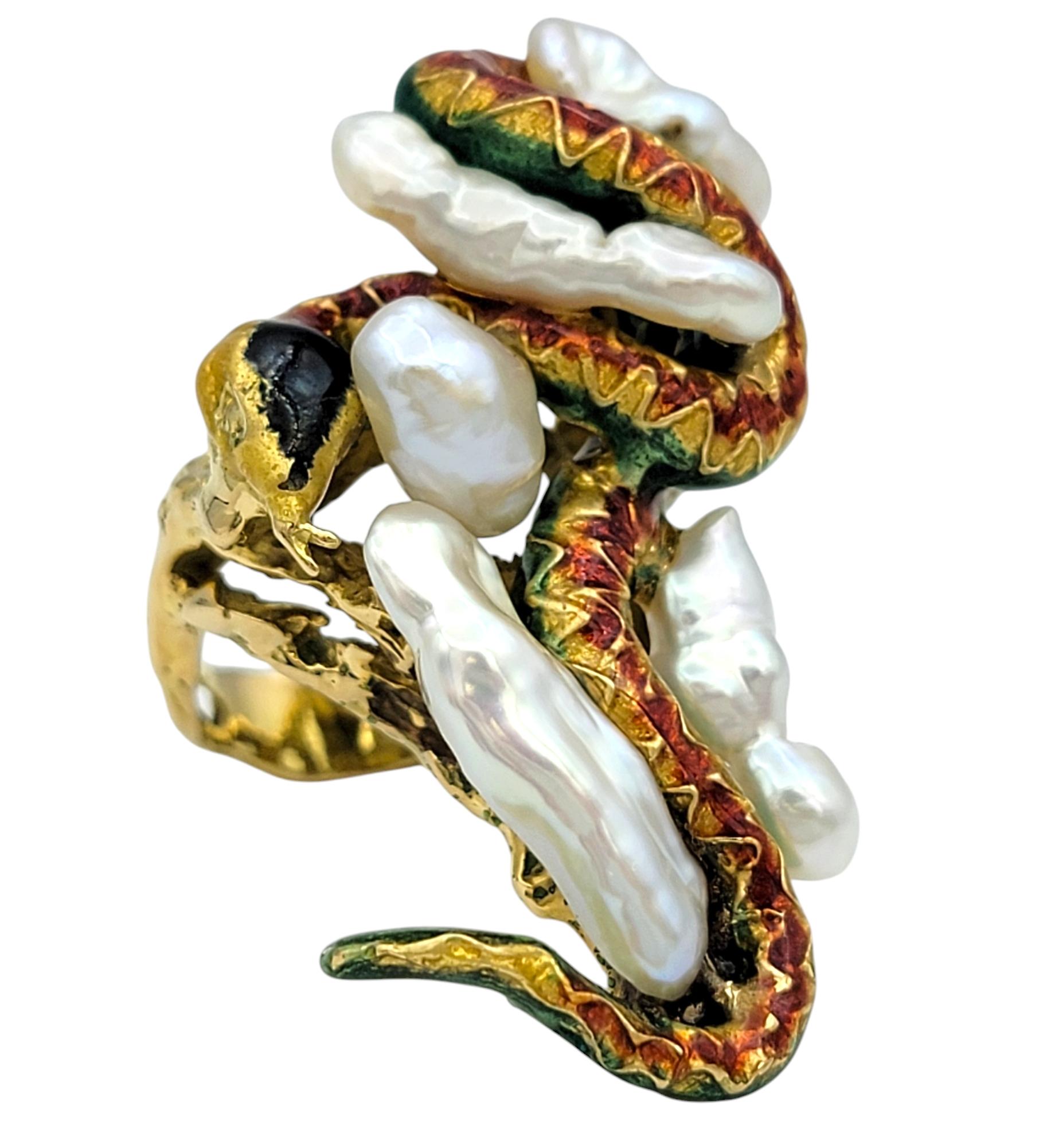 Ring Size: 6

Unleash your bold side with this mesmerizing sculptural snake ring, a true work of art crafted in 18 karat yellow gold. This unique design wraps sinuously around the finger, featuring vibrant enamel detailing that brings the serpent to