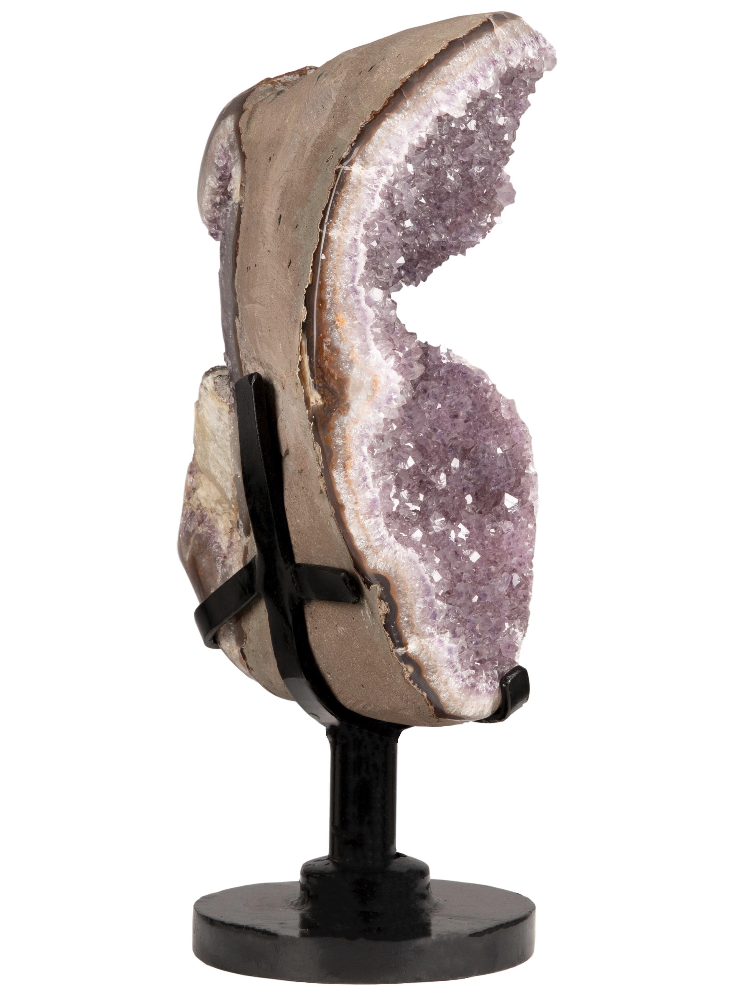 This is a unique geode heart placed in a custom rotating metal stand. Given the structure of this piece, it is possible to rotate and appreciate all the sides equally, giving the viewer an insight into the beautiful process that led to this