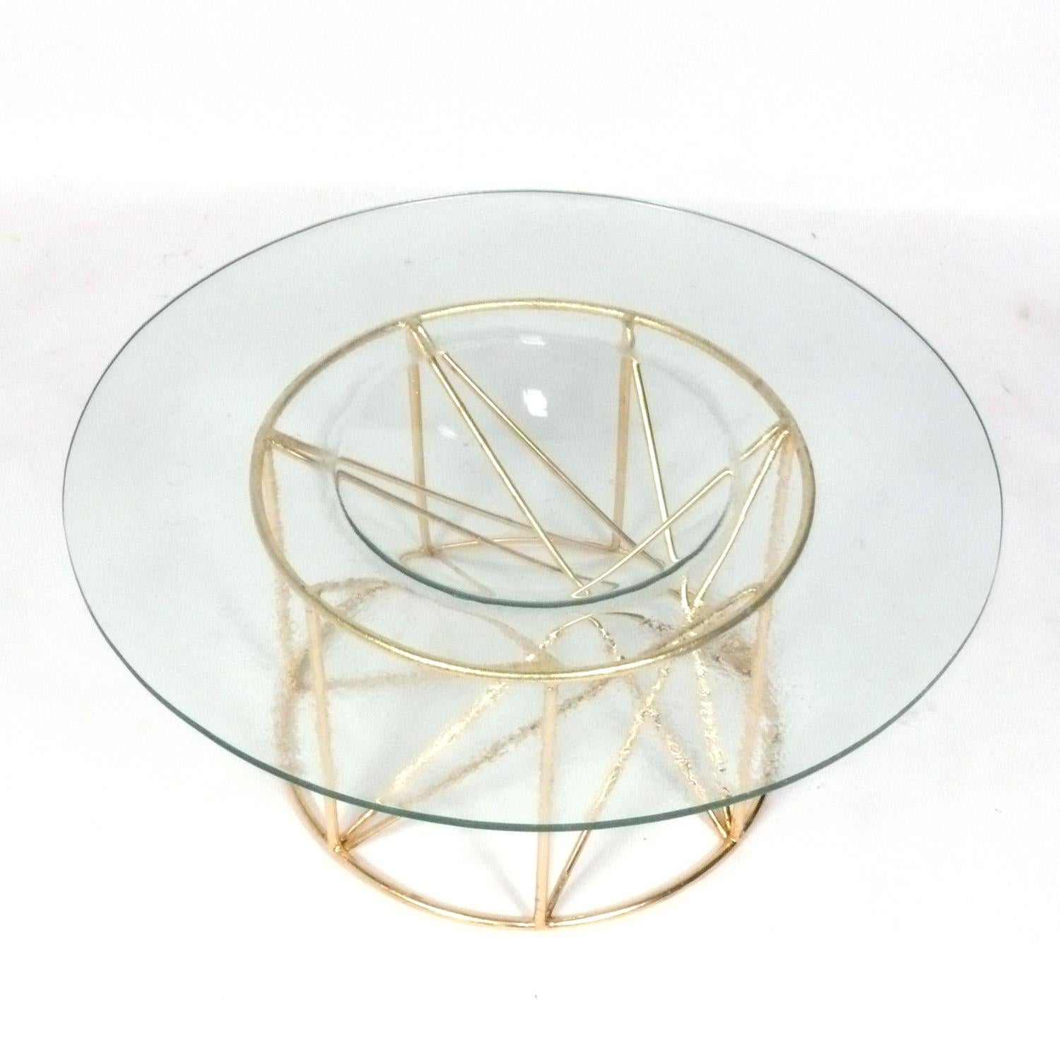 Sculptural gilt metal coffee table with concave glass top, probably American, circa 1980s.