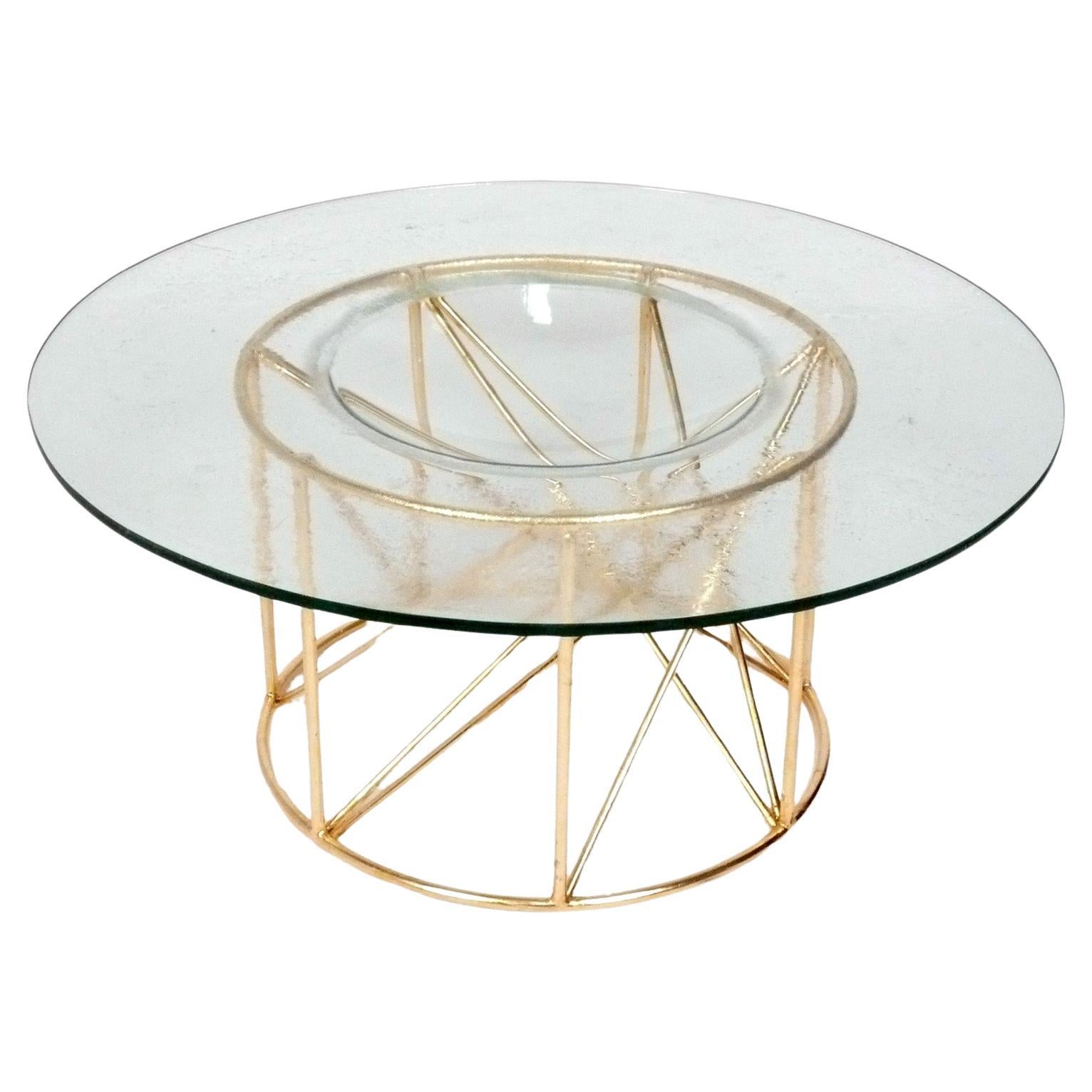 Table basse sculpturale en métal doré avec plateau en verre concave