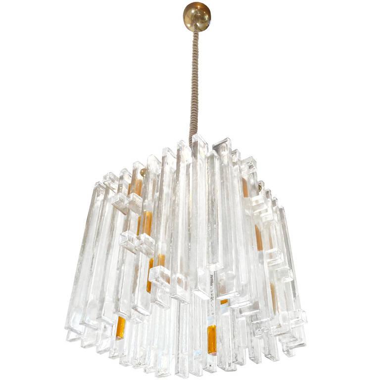 A sculptural clear glass hanging fixture with orange glass details, by Poliarte.

Italian, Circa 1970's