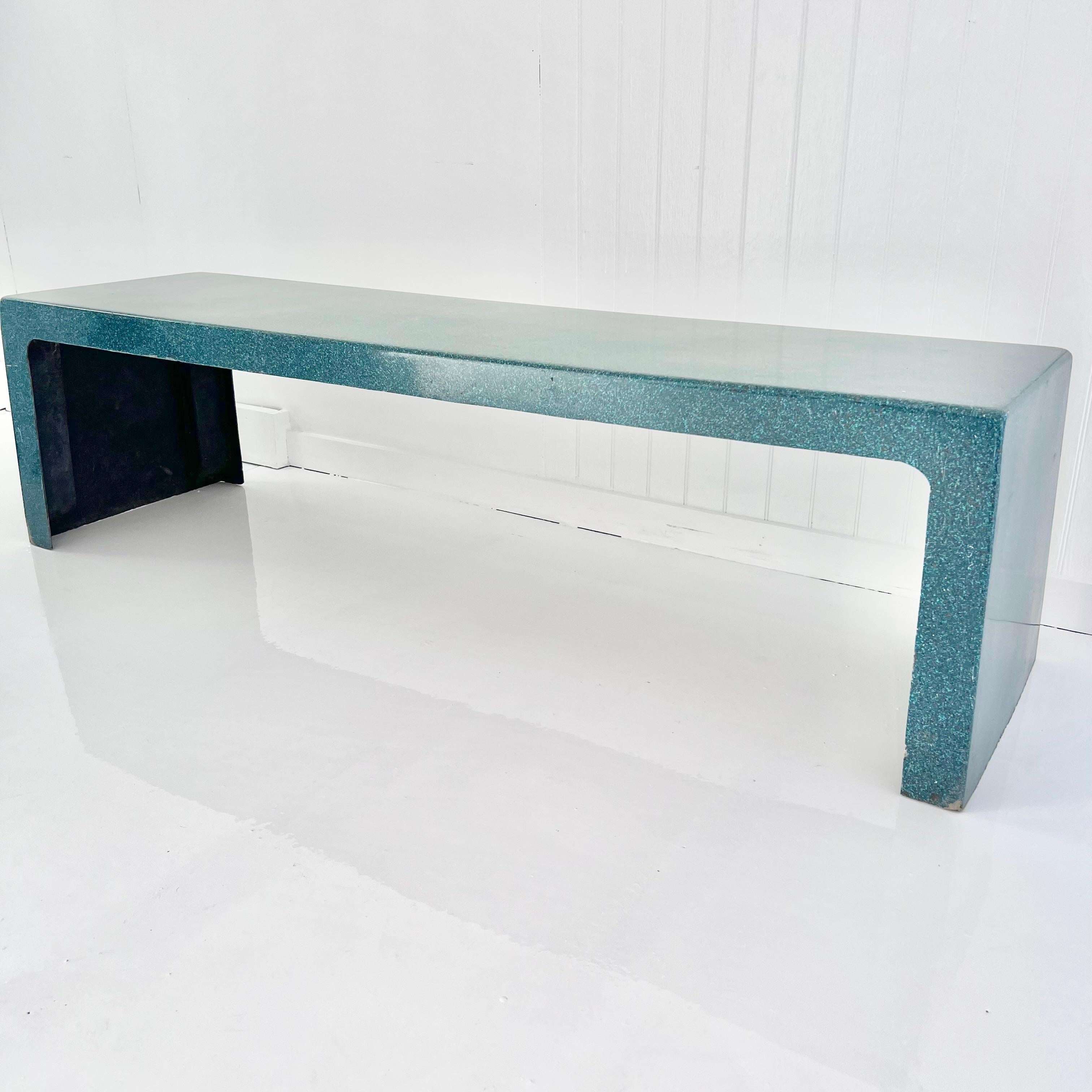 Beautiful sculptural fiberglass bench in a green sparkle finish. Simplistic design with very light wear. Single piece of fiberglass sculpted with great lines from all angles. Made for the outdoors but also looks great inside. Green shell with