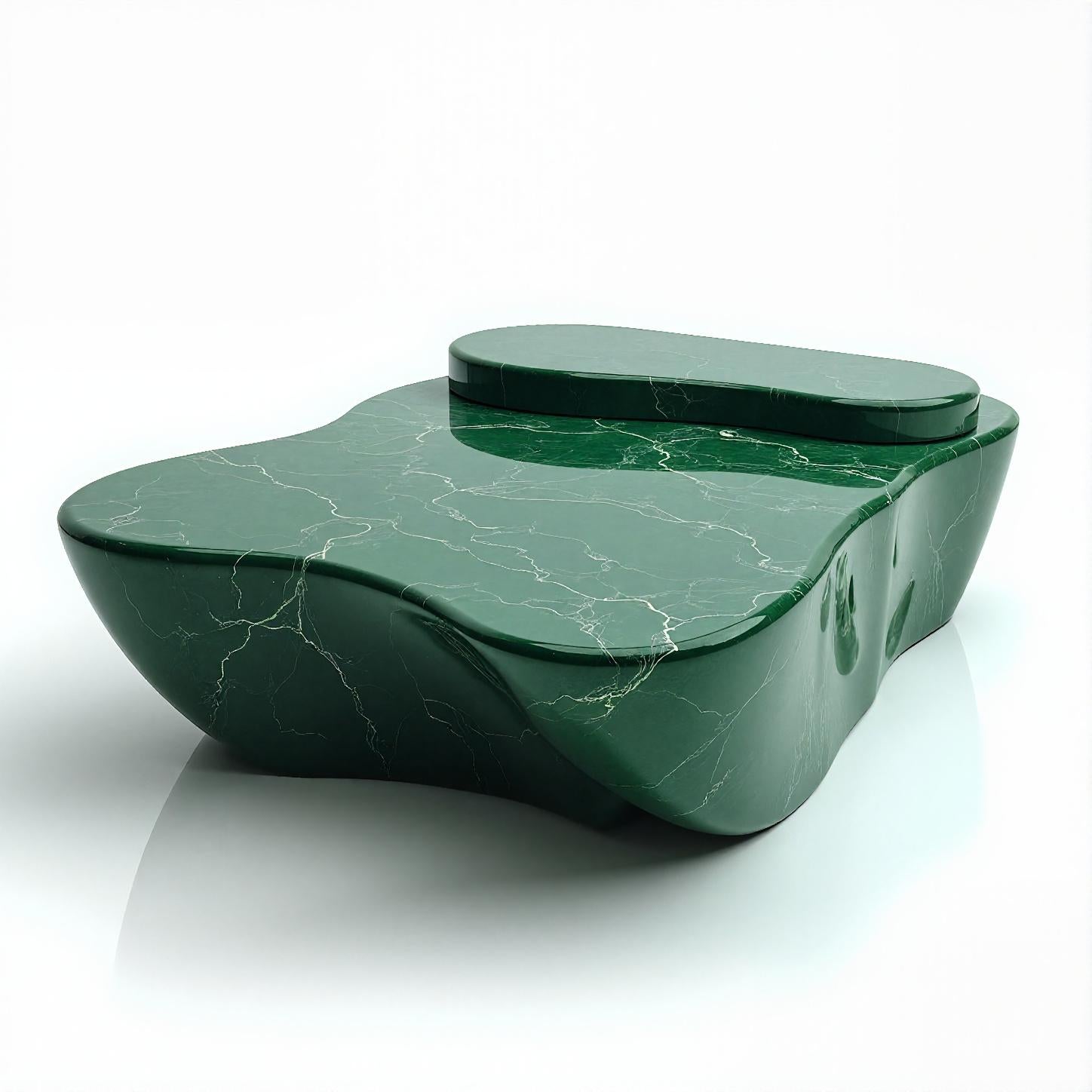 Elevate your space with this sculptural green marble coffee table, meticulously carved from luxurious Verde Alpi marble. The fluid, organic silhouette captures the essence of natural forms while delivering a bold modernist presence. Its dual-height