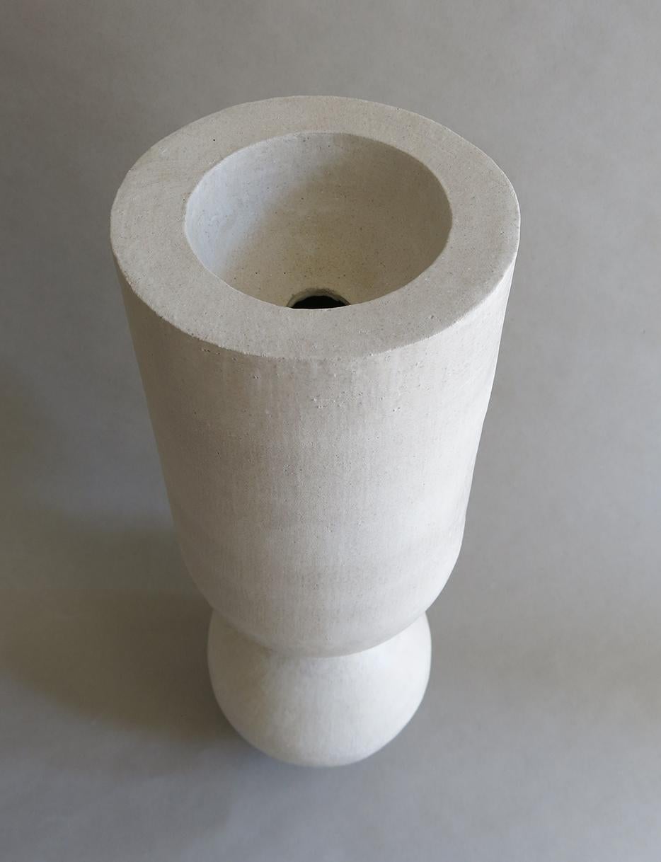 This exquisite sculptural ceramic stoneware BBL-6 Vessel by Humble Matter is hand-built out of an off-white textured stoneware with a smooth semi-matte glaze, which reflects a subtle hue that changes with the light. The piece measures 19