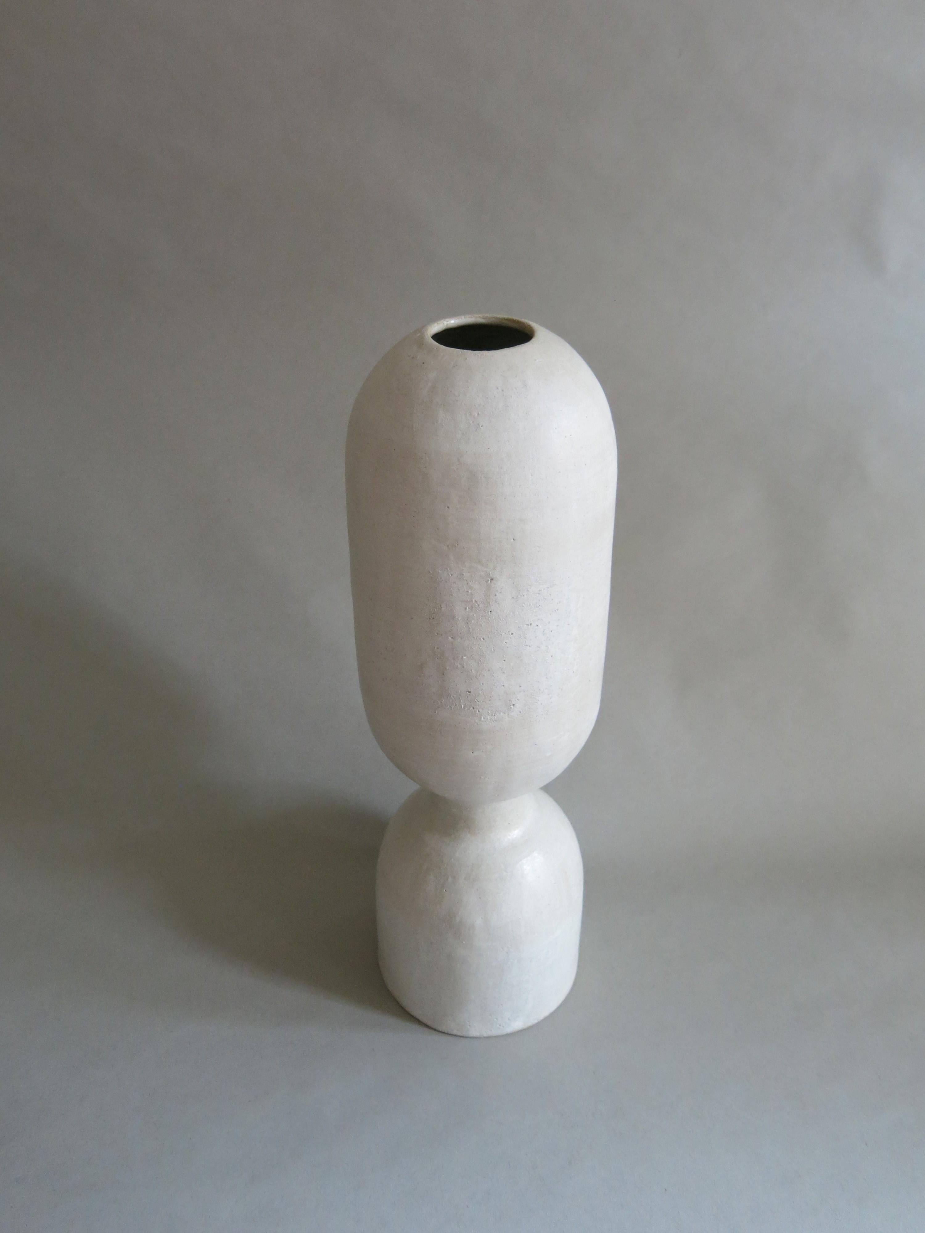 This exquisite sculptural ceramic stoneware BBL-8 Vessel by Humble Matter is hand-built out of an off-white textured stoneware with a smooth semi-matte glaze, which reflects a subtle hue that changes with the light. The piece measures 
16.5