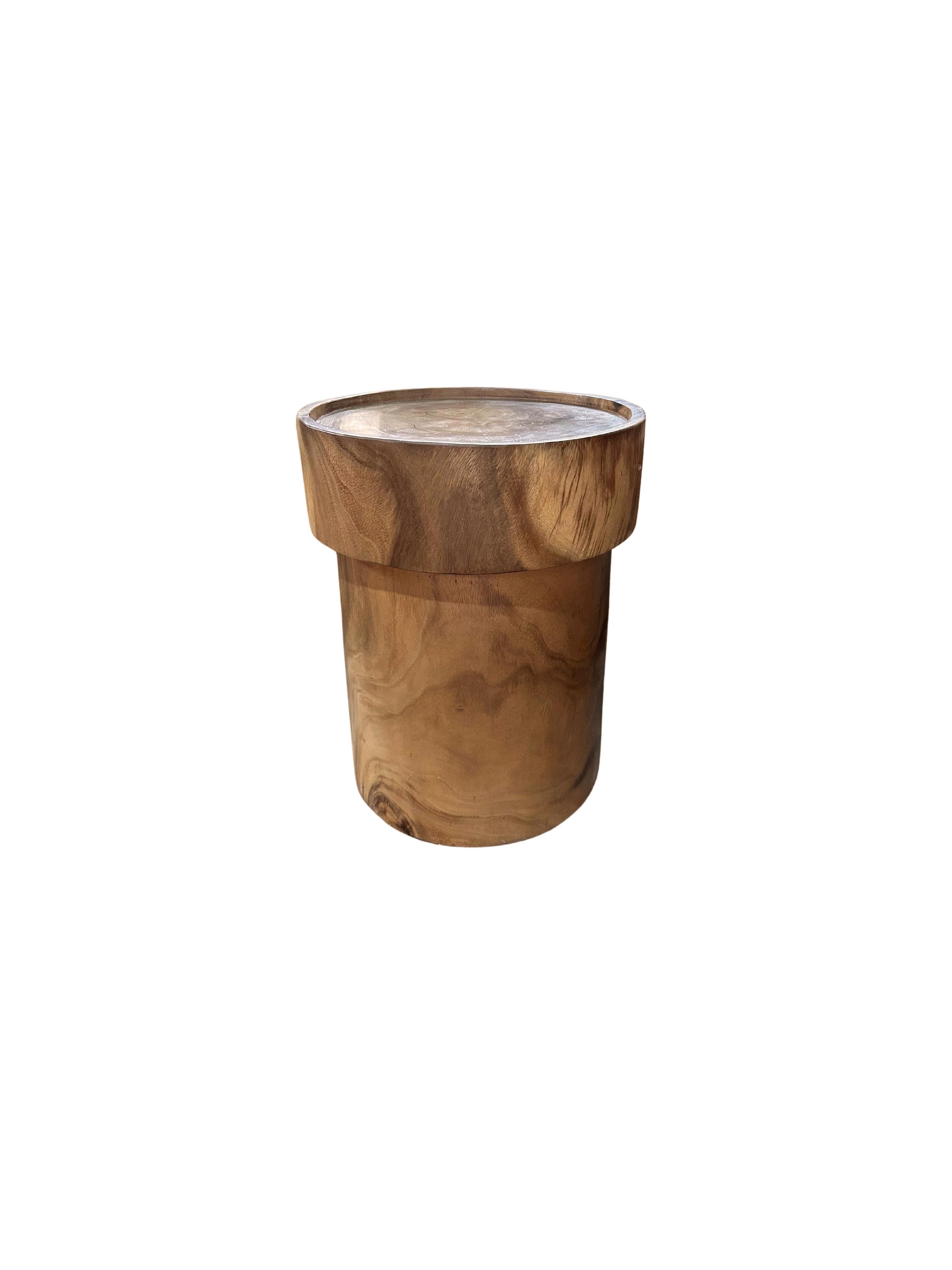 This stunning Suar wood side table showcases the beauty of natural craftsmanship with its rich, warm tones and unique grain patterns. The table features a smooth, natural finish that enhances the inherent character of the wood, highlighting its