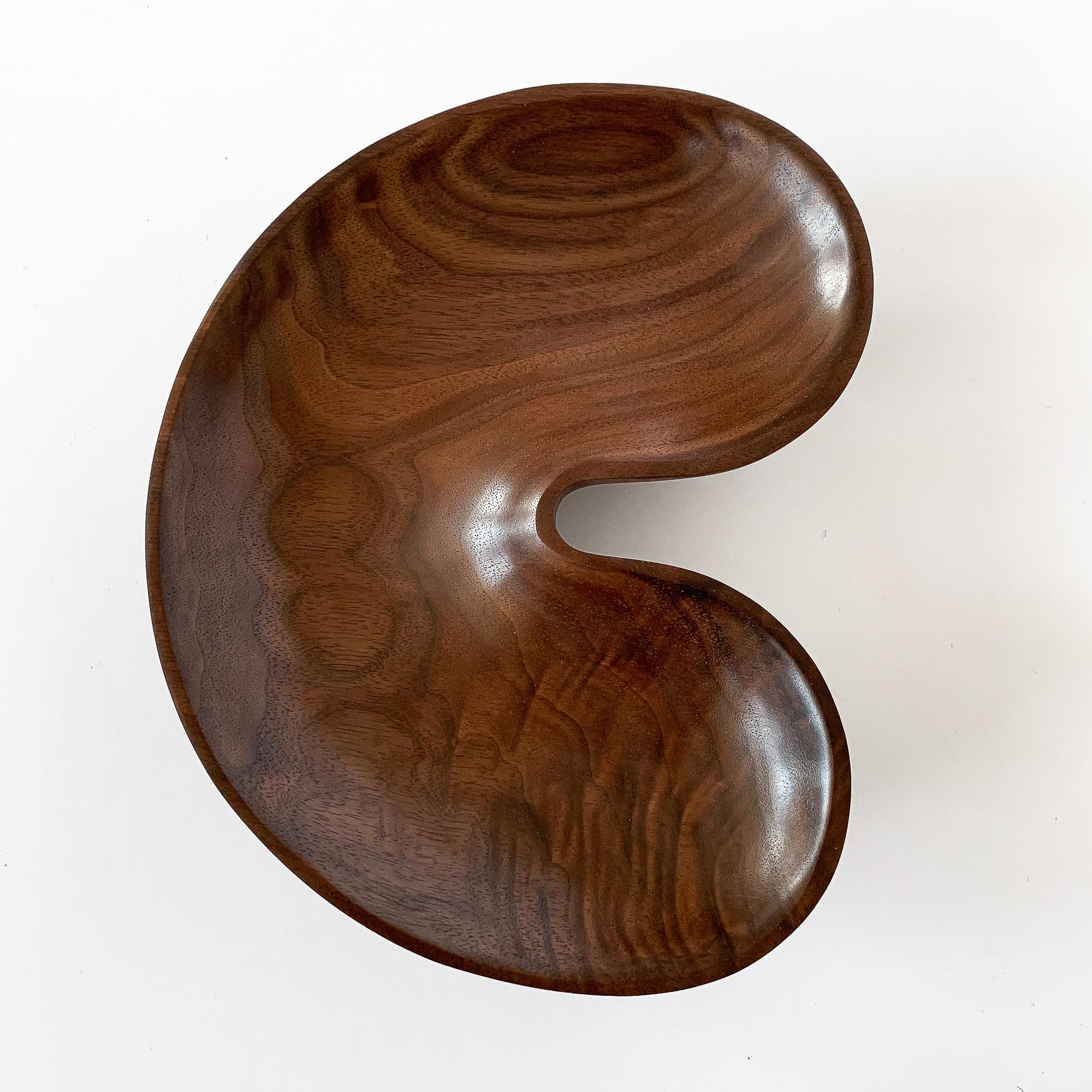Small sculptural hand carved solid walnut bowl from the Native Tongue Collection by Foxwood Co. Foxwood Co. is the work of Casey Reed Johnson, a designer and sculptor whose work is inspired by function and driven by form. His current work explores