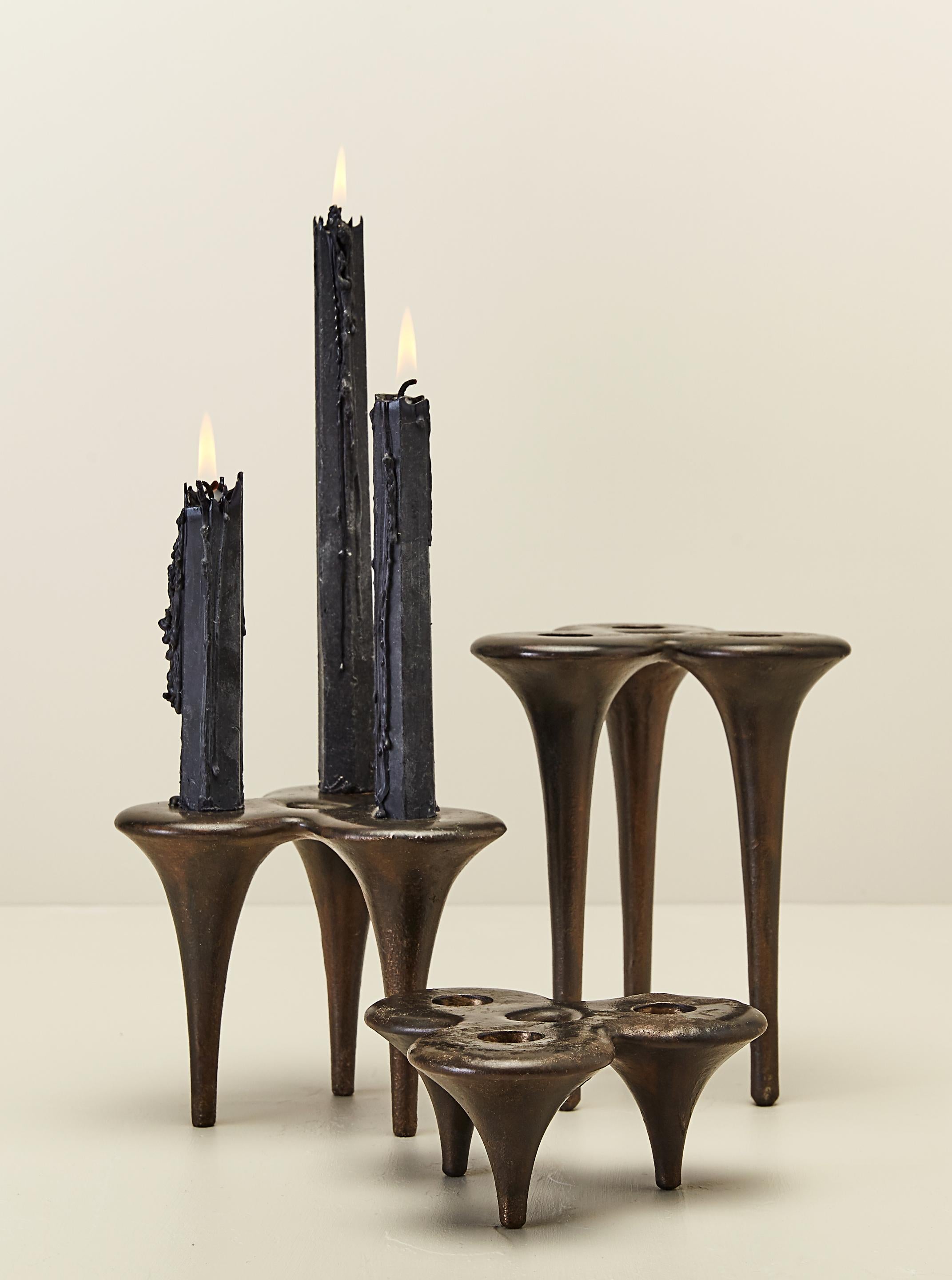 These elegant and sexy candlesticks were sculpted in wax then sand cast in solid bronze. They taper like a Manolo stiletto but finished with a rustic patina that brings them down to earth. Handmade by artist and designer Daniel Oates in small