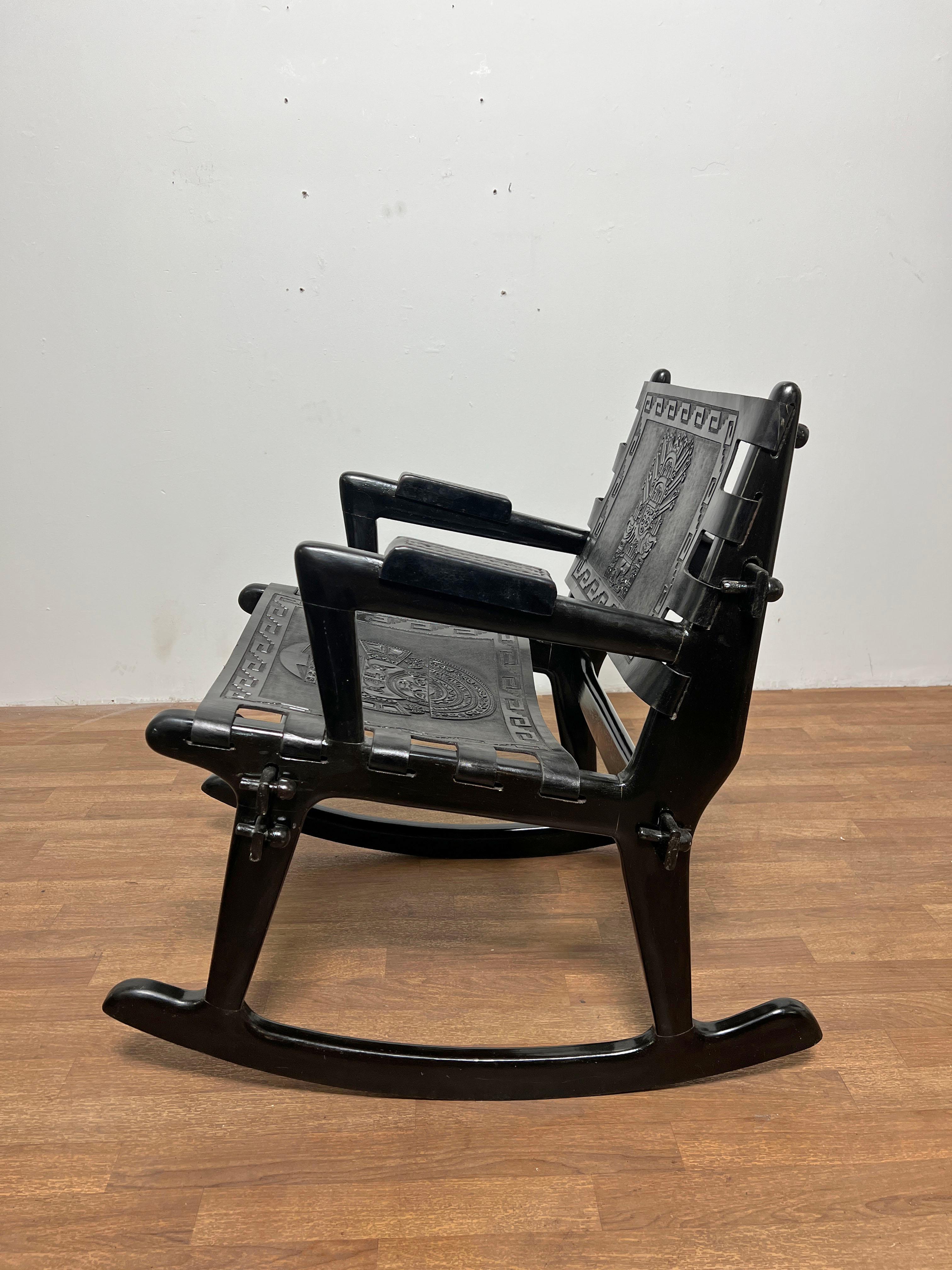 Modernist rocking chair inn leather and carved wood by Angel Pazmino, Ecuador, circa 1960s. 

