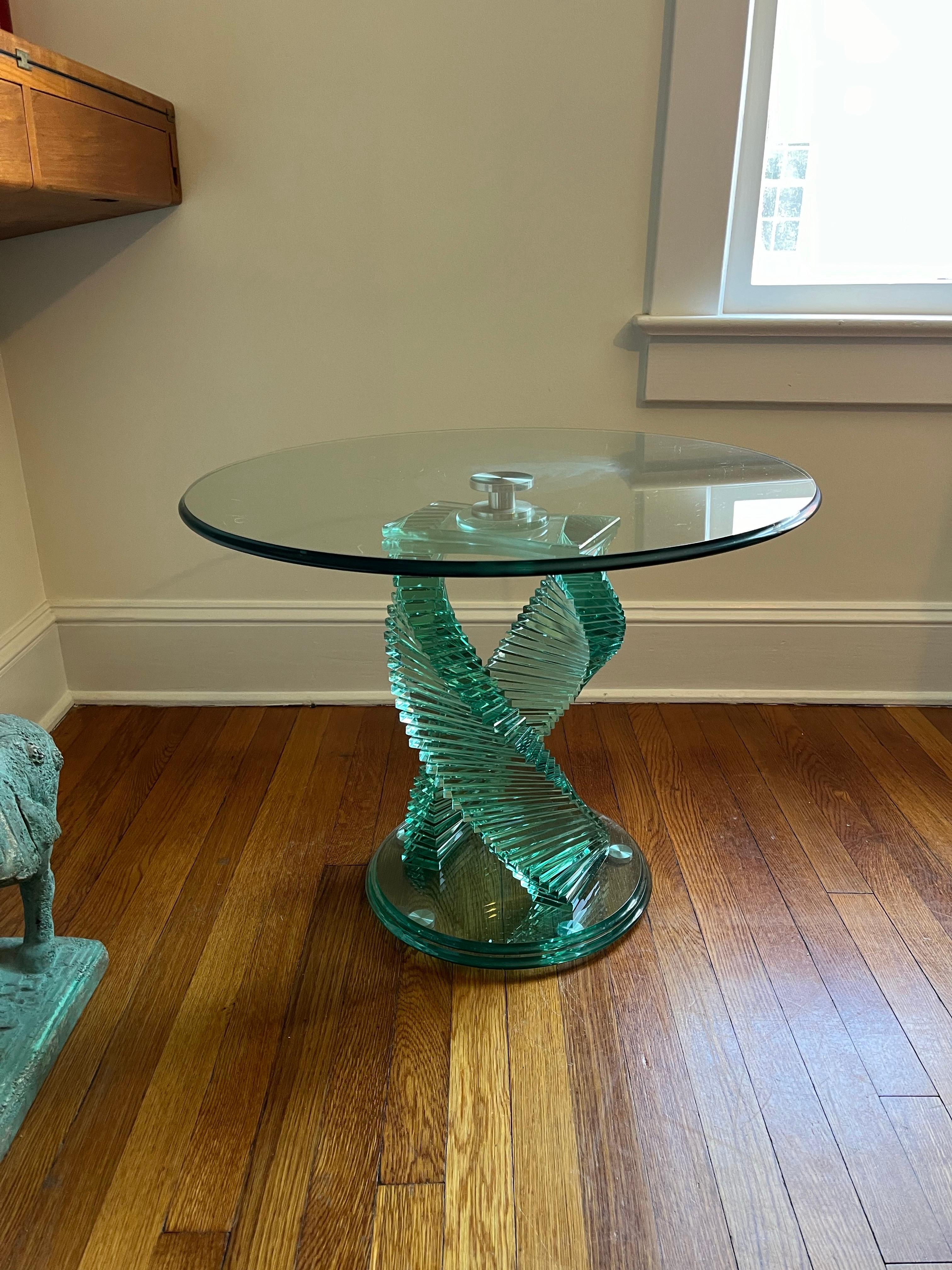 Vintage helix spiral stacked glass table. Twin helix spiral design, with stacked glass rectangles and steel hardware. Beveled glass top.
Curbside to NYC/Philly $450