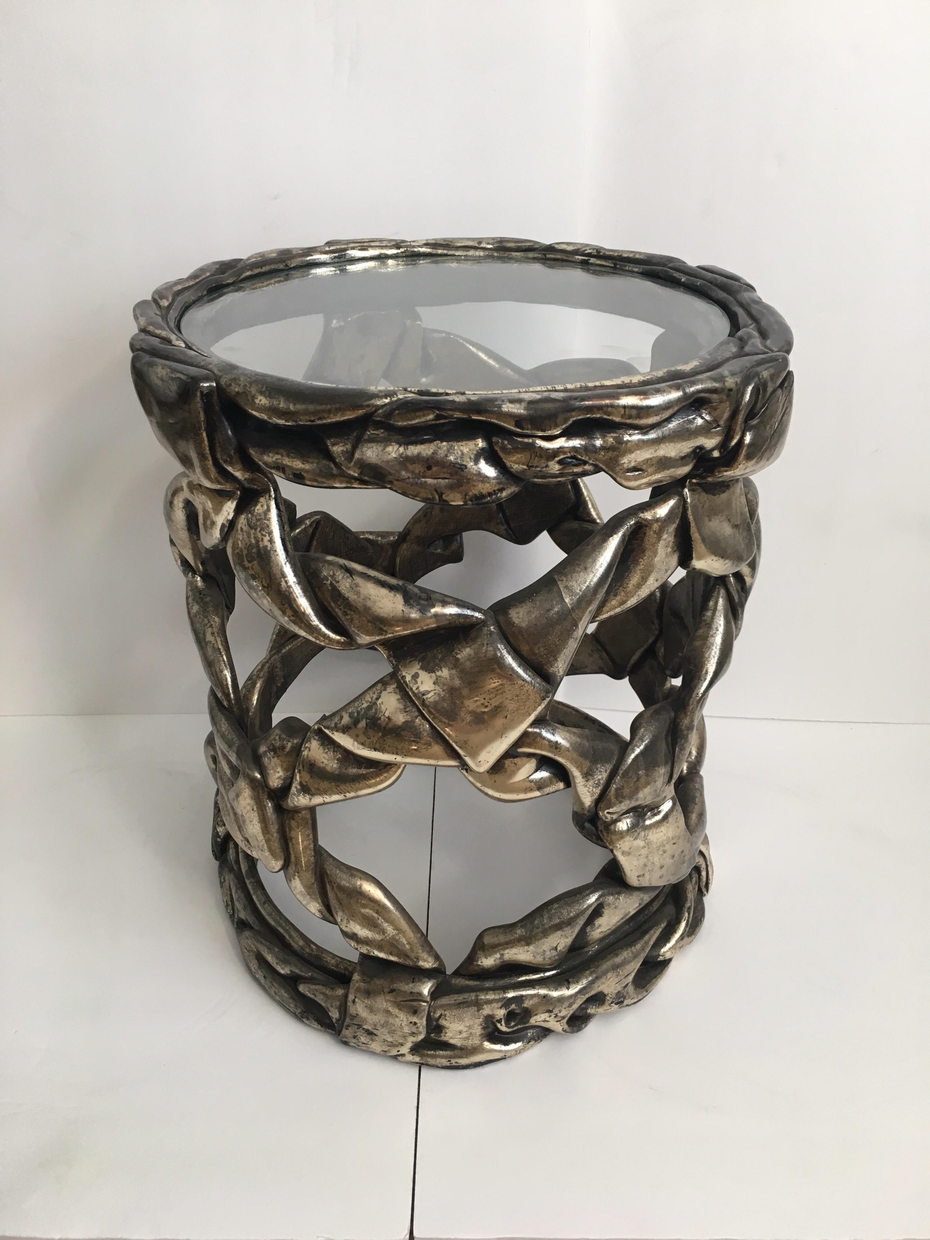 Delicious candy ribbon occasional side table in the Hollywood Regency style of Tony Duquette. Features Original silver leaf finish with natural patina showing gunmetal gray/aged chrome undertones. This sculptural Mid-Century Modern piece has a