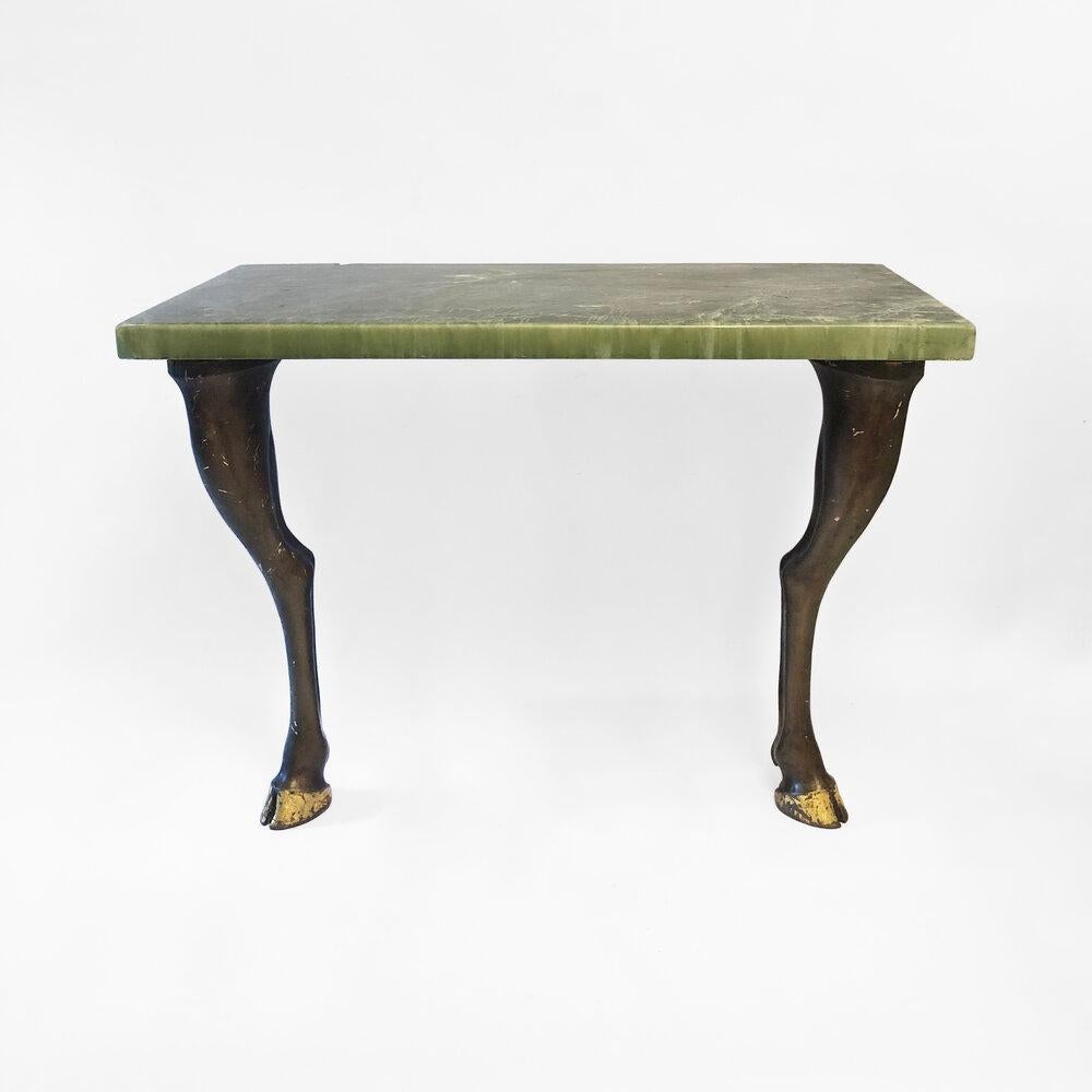 A marble resin console table, held up by a unique set of two plaster horse legs that originally supported an Arts Deco drinks cabinet. The cabinets didn’t make it through time, but thankfully the legs survived. They were a made-to-order item for its