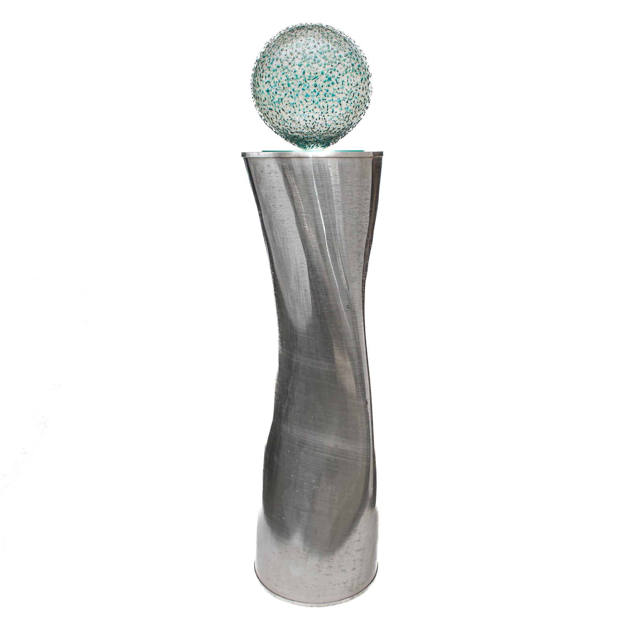 Sculptural industrial silver aluminum filter with a hand-blown glass ball top.

The sculptural piece is created from an aluminum filter with a hand-blown glass ball mounted on top. The glass ball has a flat bottom so it sits firmly on the aluminum