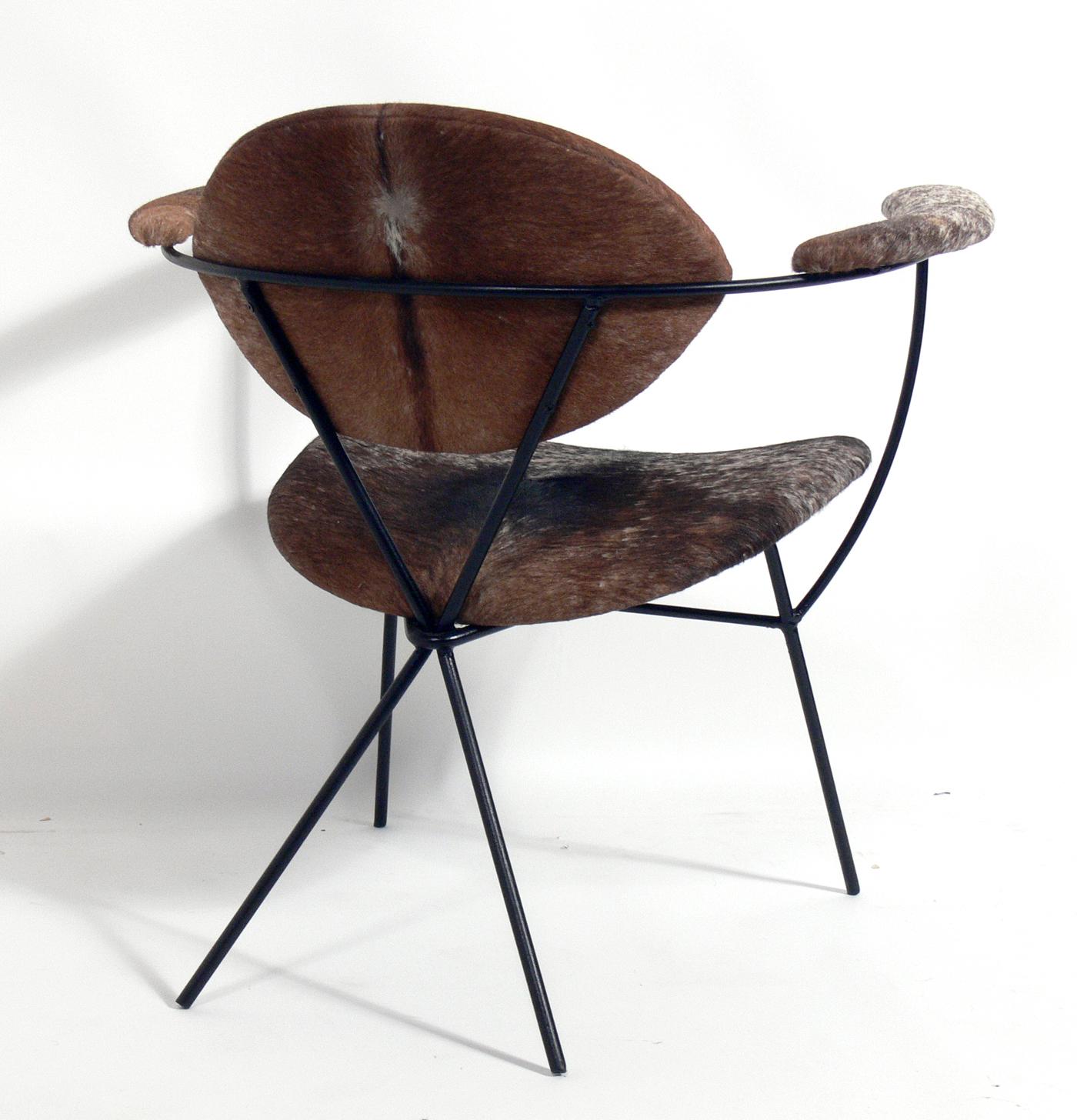 Sculptural iron and cowhide lounge chair by Joseph Cicchelli for Reilly Wolf, American, circa 1950s. It has been recently reupholstered in cowhide and the iron frame repainted.