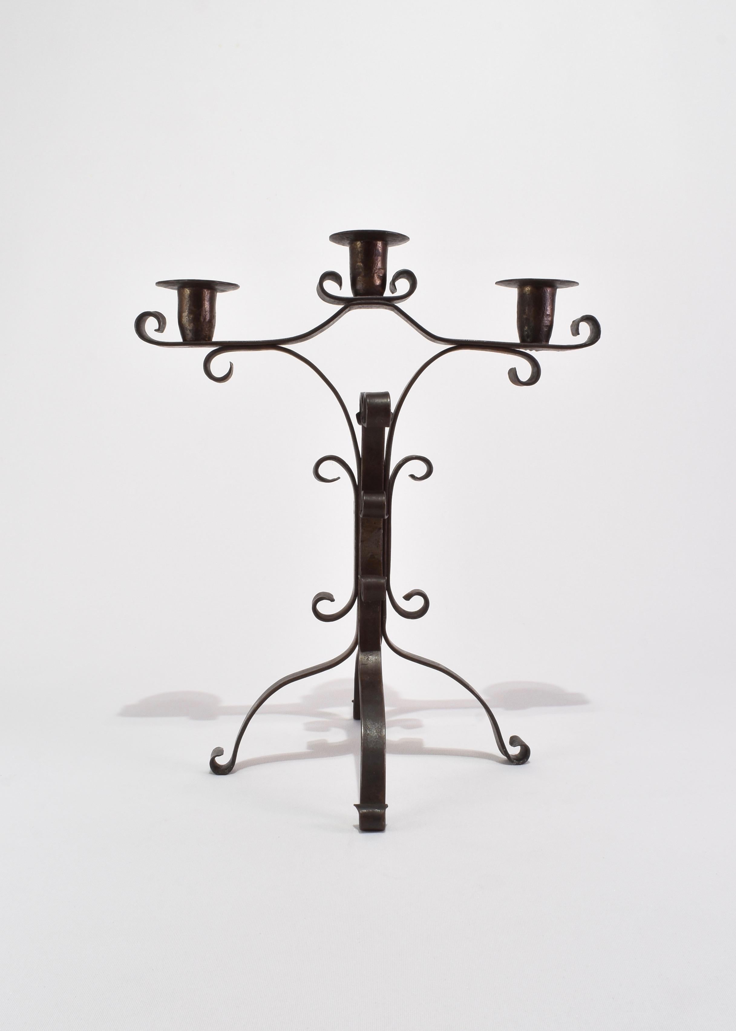 Vintage hand-crafted sculptural iron candelabra with scroll detail and three candleholders. Beautiful as a mantle piece, or use to complete your table scape. 