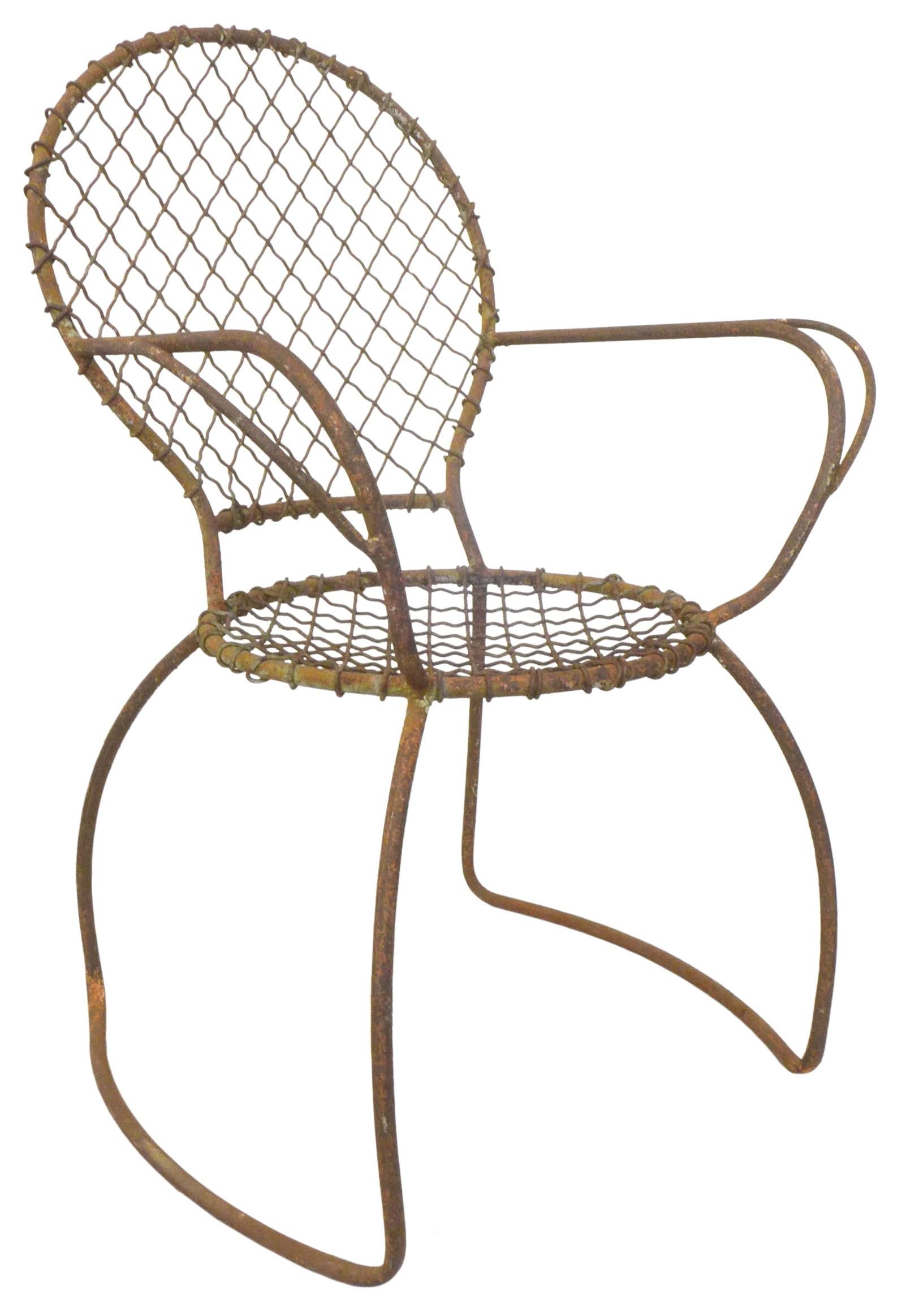 A wonderfully sculptural and playful outdoor chair with unusual decorative lines and form. Constructed of iron tubing with iron mesh elements for the seating and backrest areas. This utilitarian and artful seating design possesses a rich and desired
