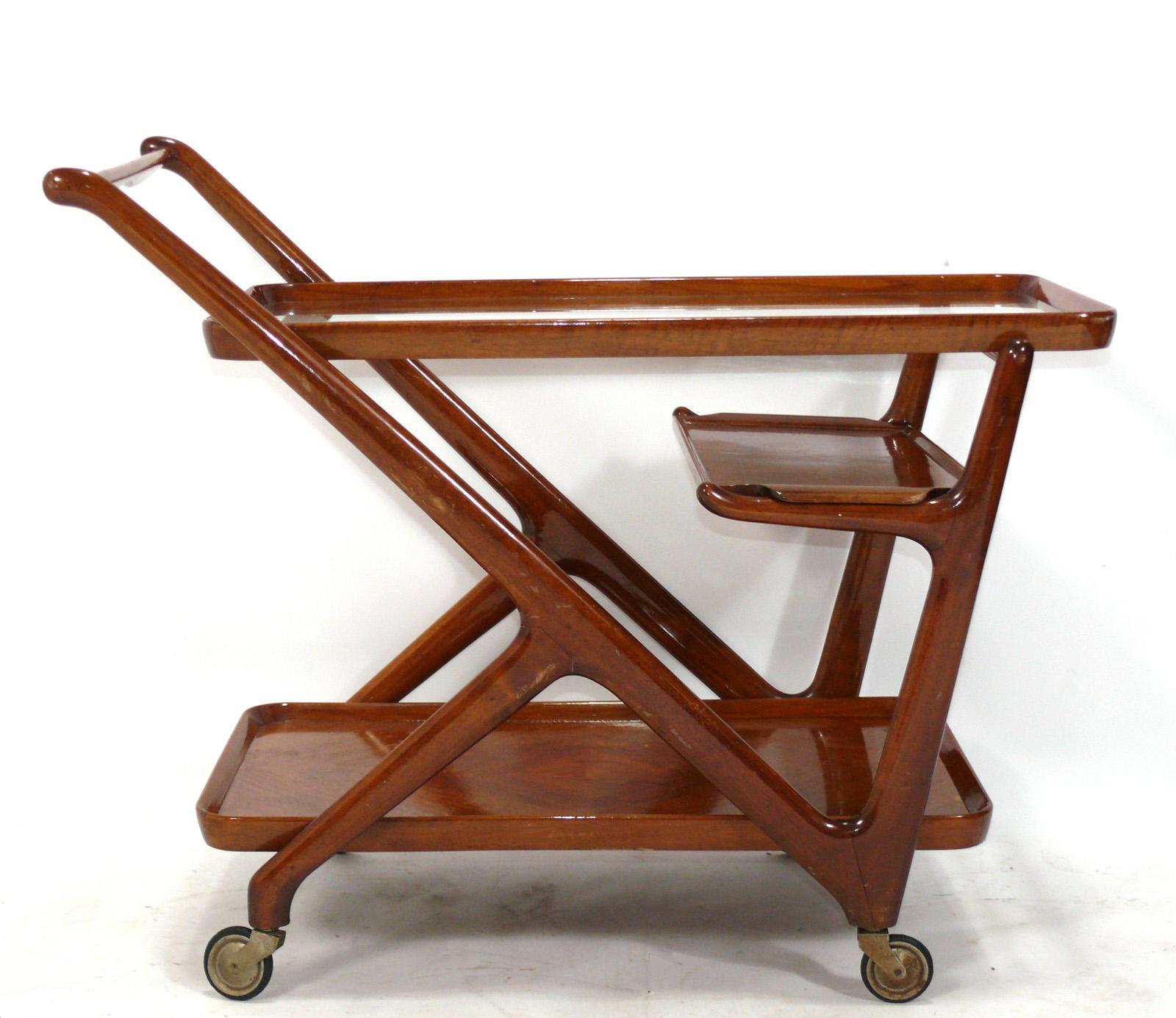 Sculptural Italian Bar Cart, designed by Cesare Lacca, Italy, circa 1950s. It is constructed of beautifully grained wood and has a removable tray.