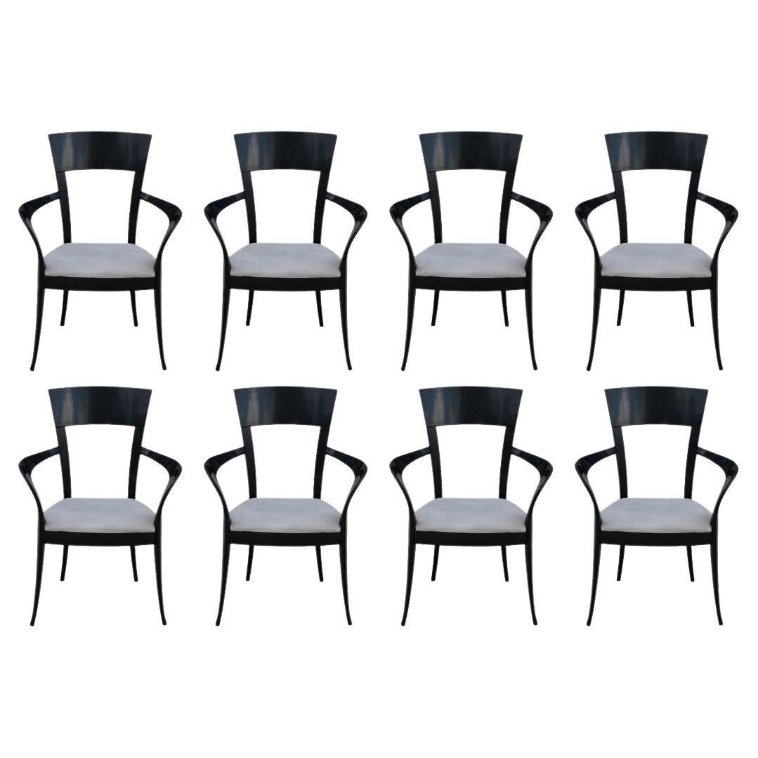 Stunning and rare set of eight sculptural dining chairs made in Italy by designer Pietro Costantini. The armchairs have gorgeous curves, gently tapered legs, and are finished in black lacquer. These unique chairs were brought over from Italy when