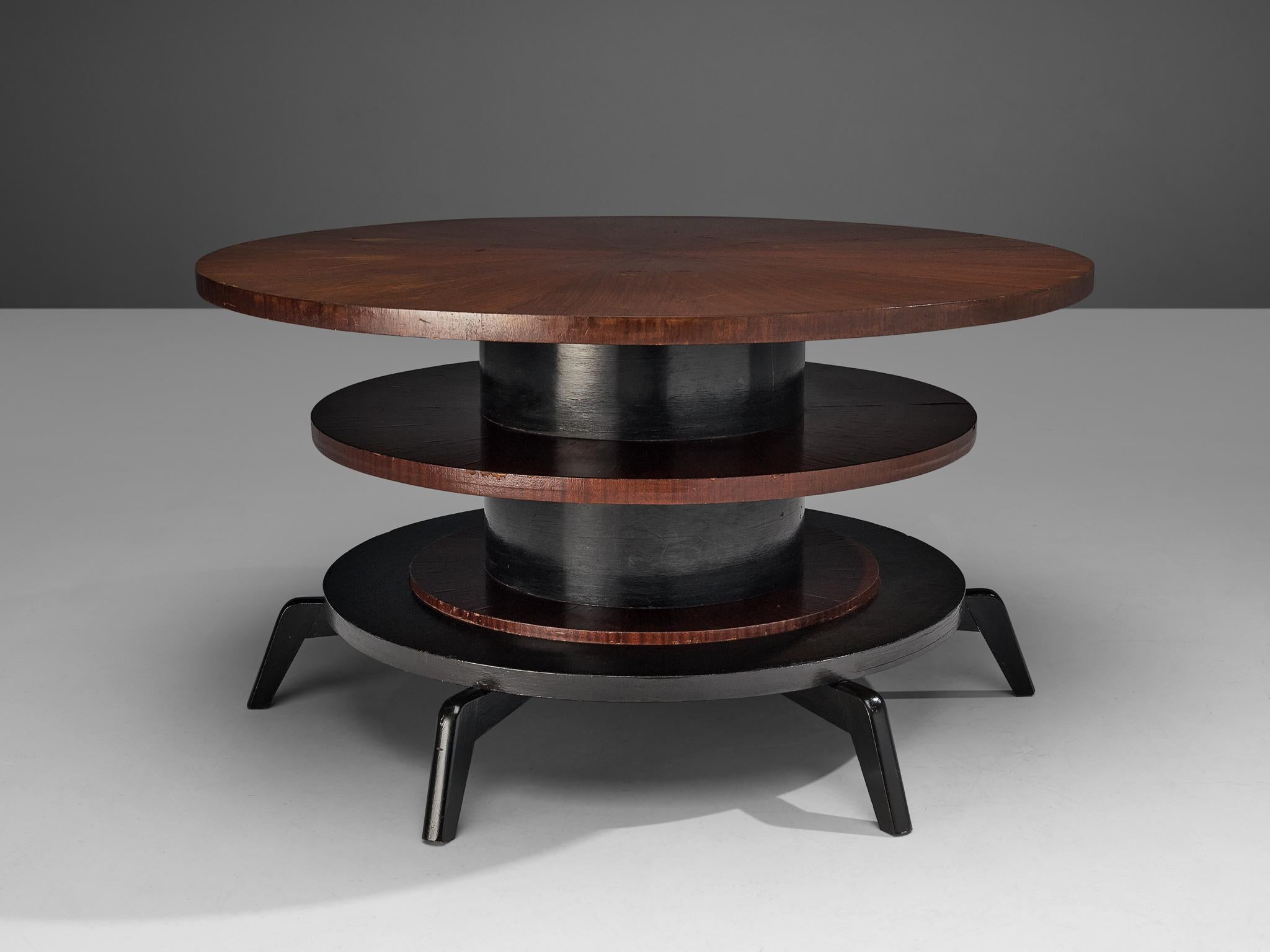 Center table, mahogany, lacquered mahogany, Italy, 1960s

Multi-layered center table with modernist look. The table has a sculptural, yet open look which is achieved by the different layers and angled legs. Although the table has a structural feel,