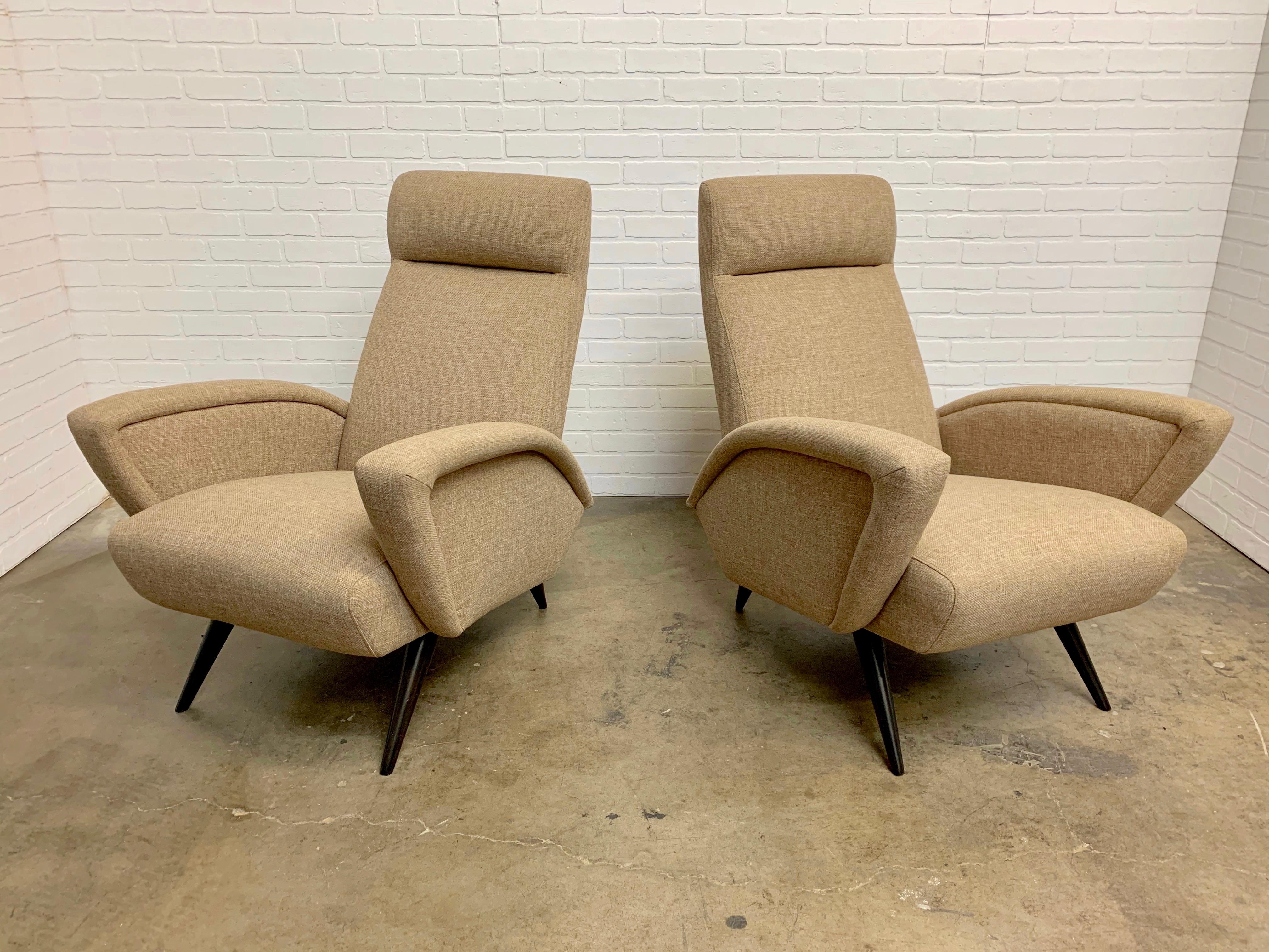 Pair of sculptural Italian lounge chairs with ebonized legs.