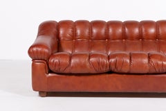 Sculptural Italian Modern three seat cognac leather sofa, 1970’s