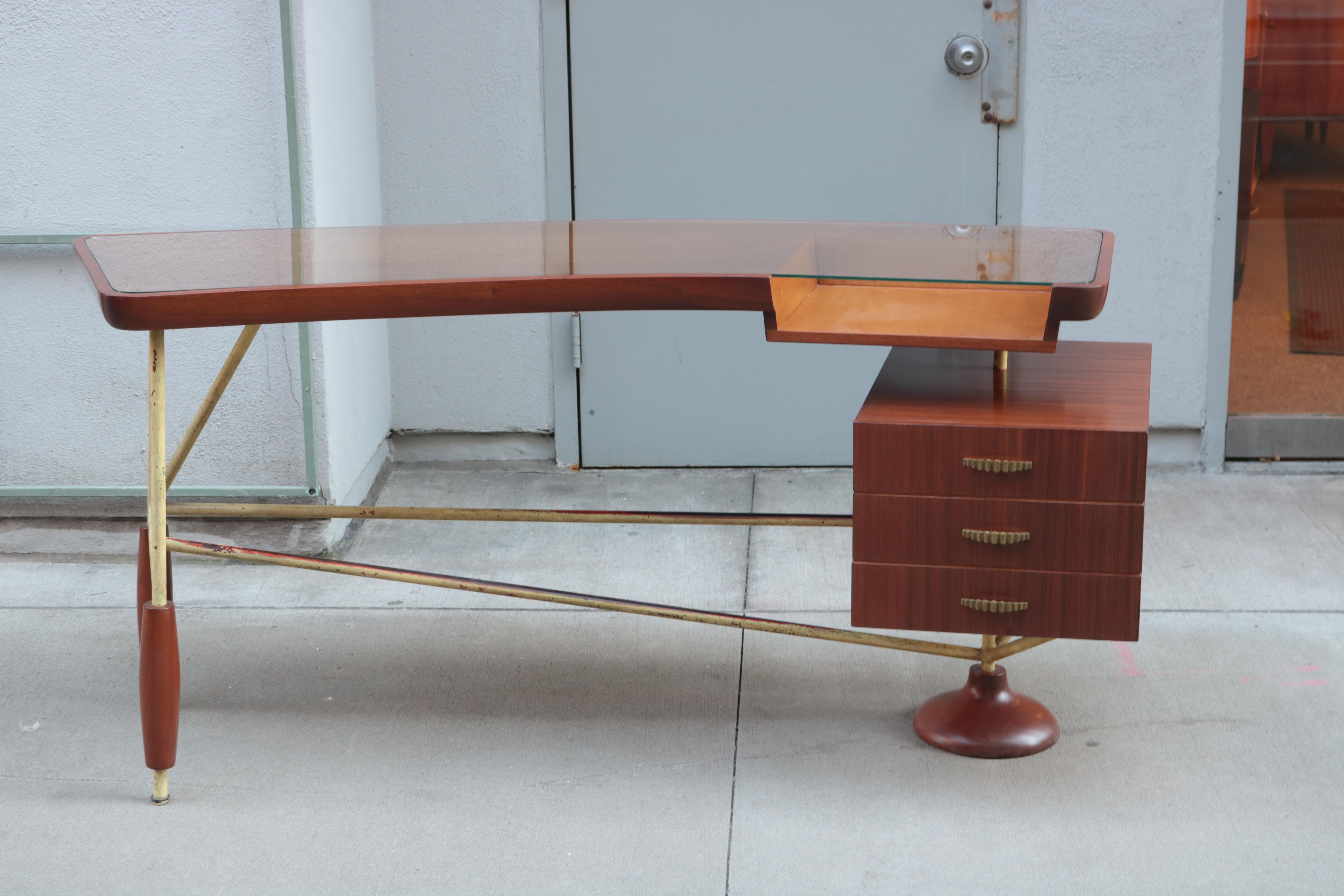Sculptural Italian modernist desk.
Mahogany with painted steel stretchers featuring aged patina,
glass top with sycamore lined cut out.
For additional charge stretchers can be refinished, plated or painted.