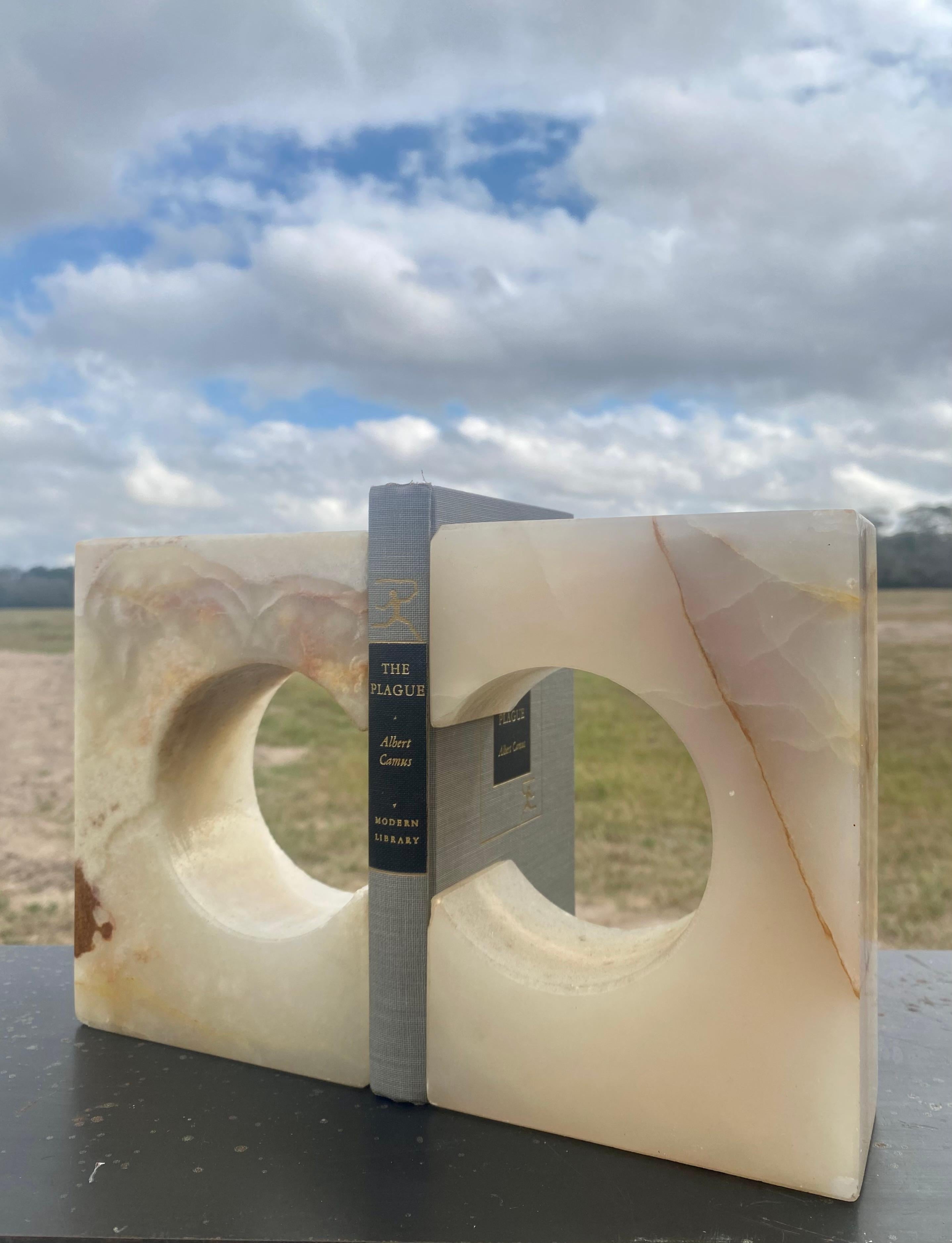 Elevate your space with the bold presence and timeless elegance of these extra-large sculptural onyx bookends. Expertly carved from genuine banded onyx, each piece is a unique work of art, showcasing the natural beauty and rich patterns of the