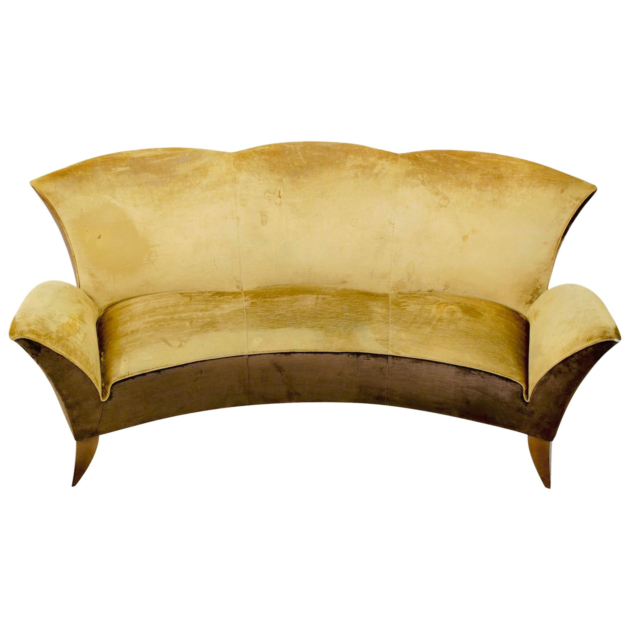 Sculptural Italian design sofa, circa 1960s. High curved back with scalloped detail for 3 seats and is upholstered to the floor. An impressive sofa from every angle. Looks to have been reupholstered in the 1970s. Front legs have been