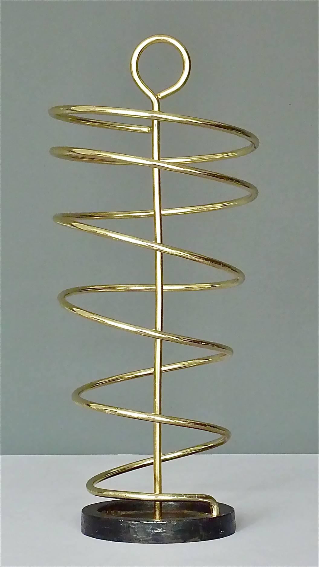Fantastic sculptural midcentury “Spirale“ umbrella stand designed and executed in the 1950´s in Italy. It is made of golden color anodized aluminum metal formed to an up-going spiral with handle and a black enameled iron base at the bottom for a