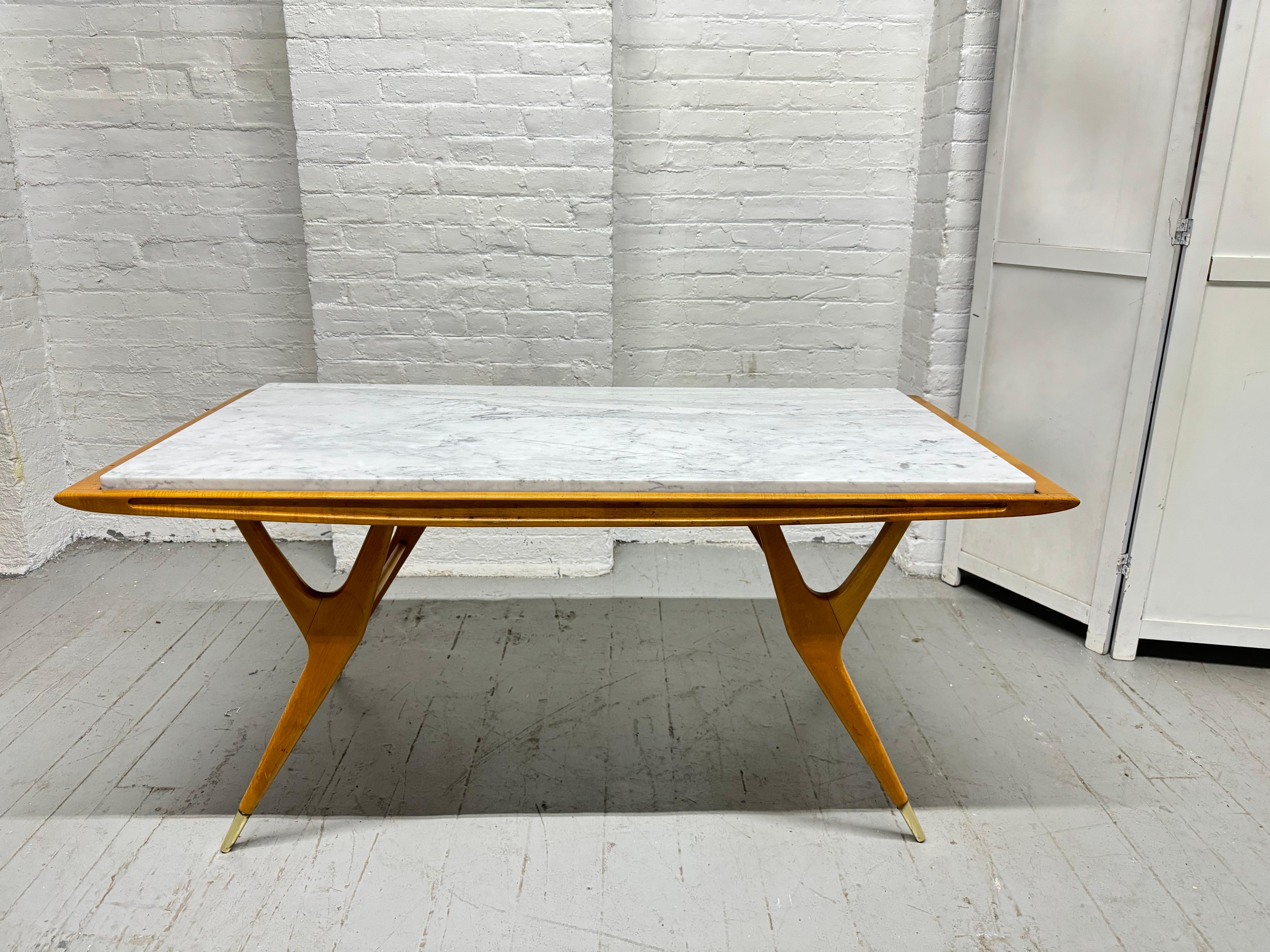 Sculptural Italian Coffee Table with a Carrara Marble Top, style of Ico Parisi.   Sculptural wood frame with brass sabots.  