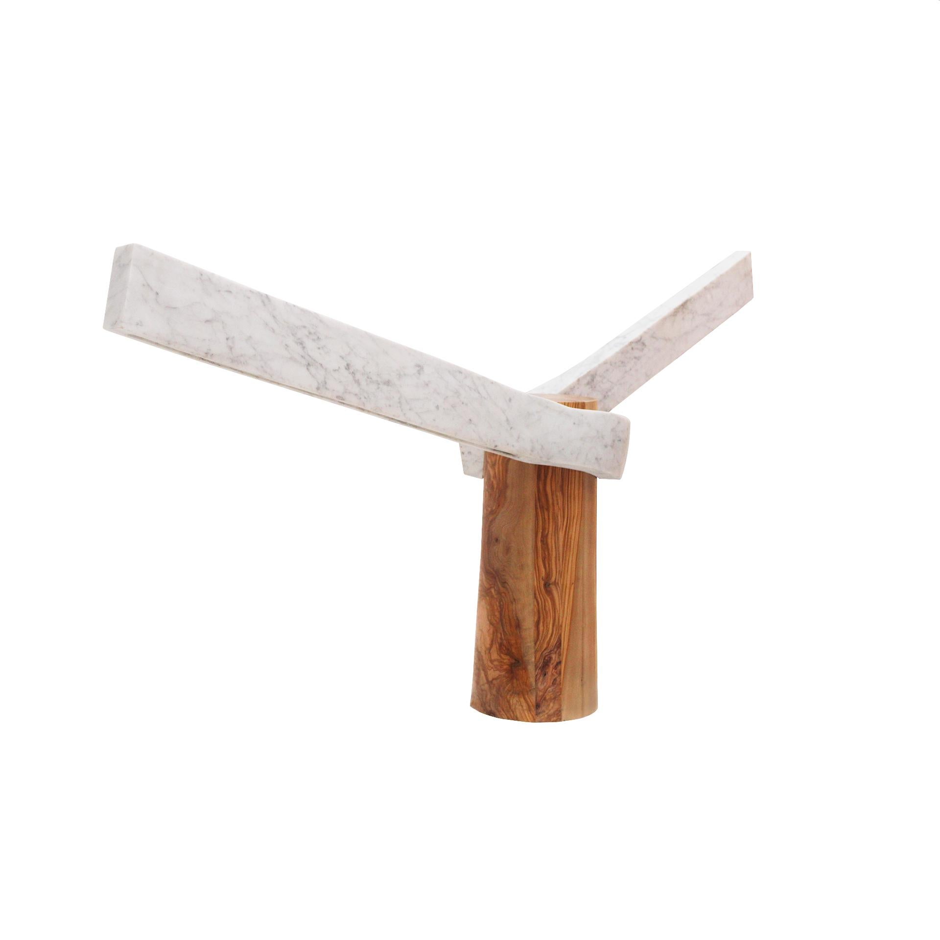 ROOT Lamp designed by Carlos Aucejo, a sculptural piece crafted from marble and olive wood.

His creations emerge from a sculptural exploration applied to furniture design. Through an artisanal approach, he seeks to infuse each piece he shapes with