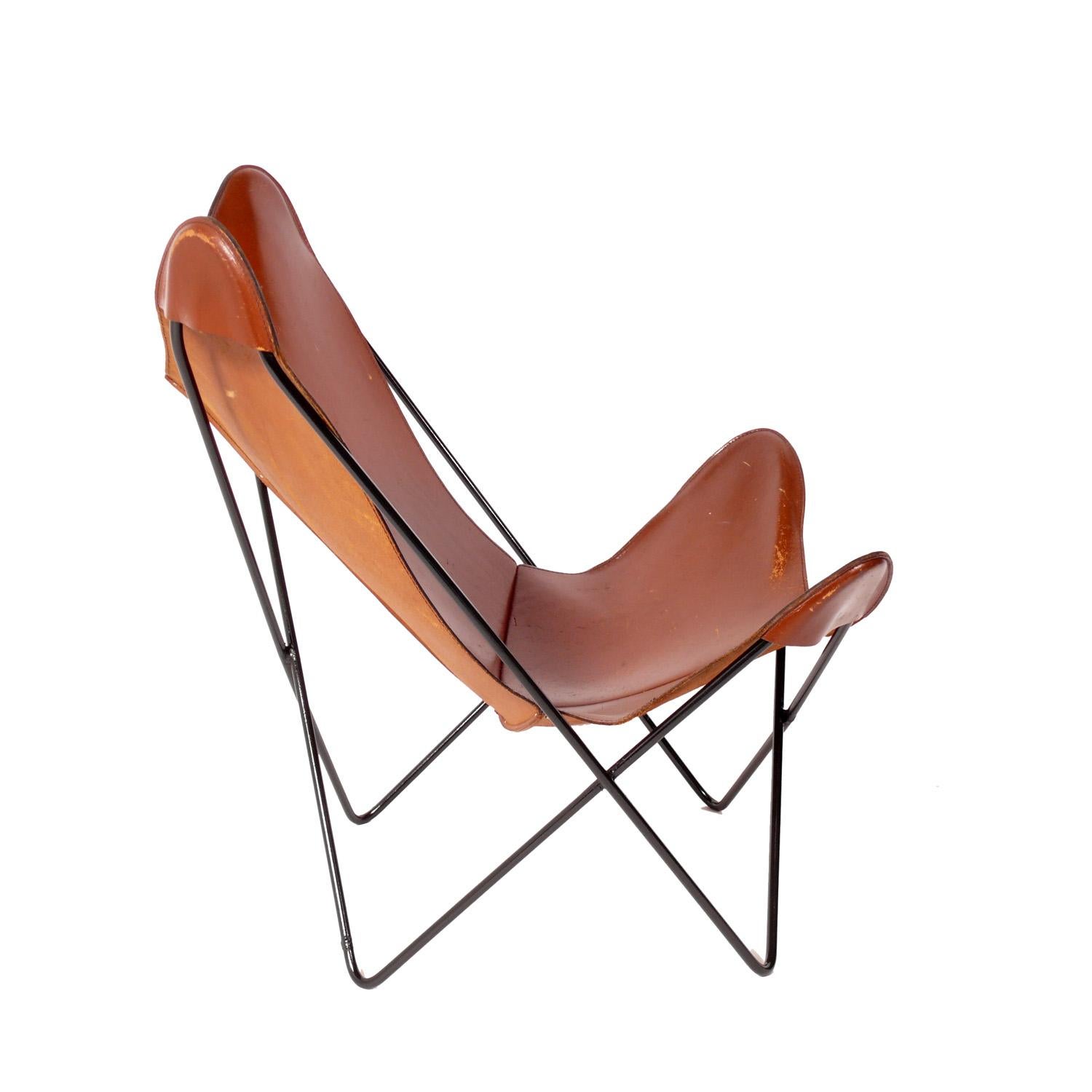 Sculptural leather butterfly lounge chair designed by Jorge Ferrari-Hardoy, circa 1960s. Rarely seen in the original cognac leather, this chair has a great patina that you only get with age. Broken in like your favorite baseball glove. The iron