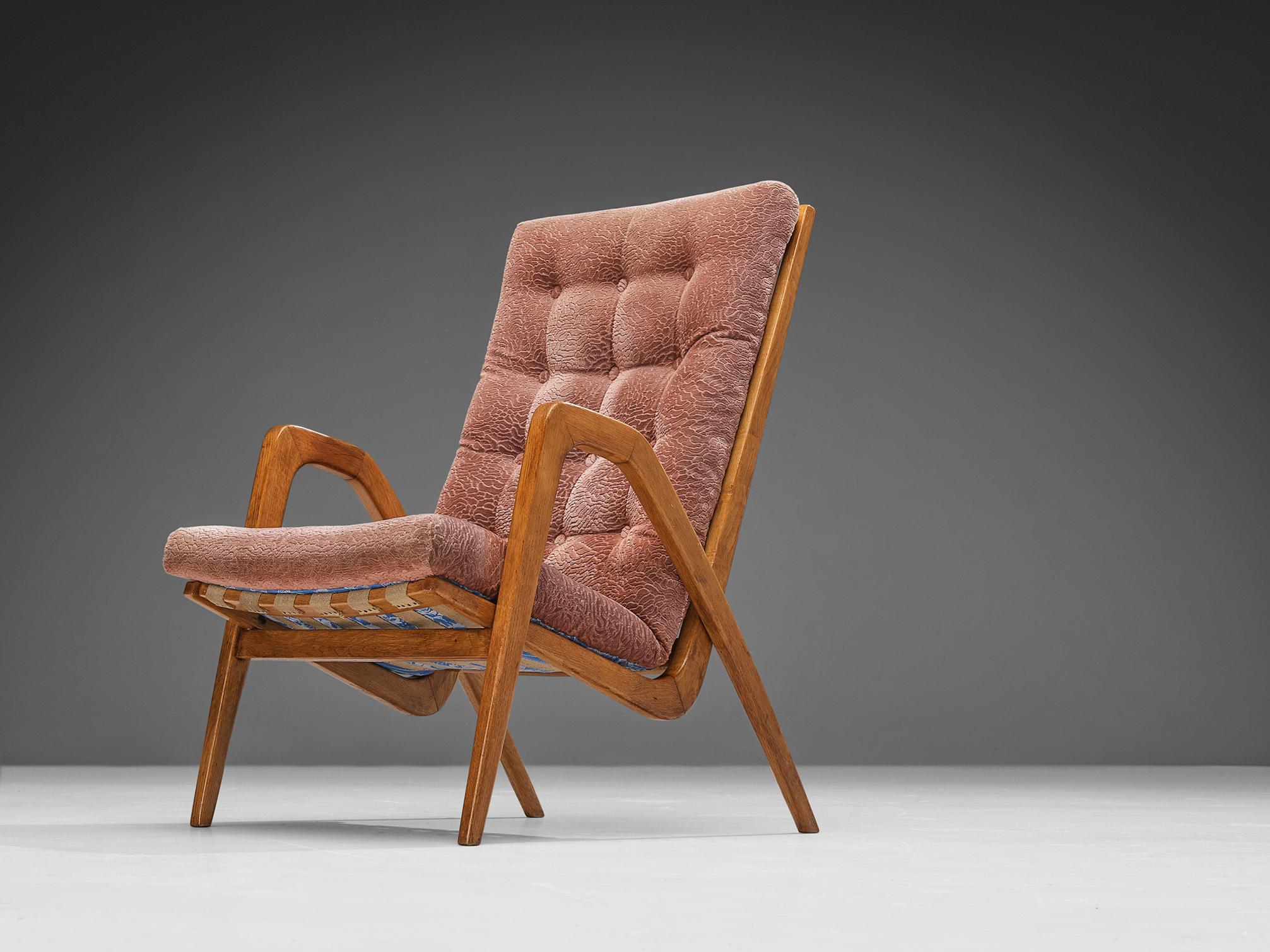 Lounge chairs, oak, fabric, Europe, 1950s

Refined lounge chair that features a high backrest and sculptural form. The chair is made in the late Art Deco period, as they show its distinctive characteristics, such as the thick tufted seat and the